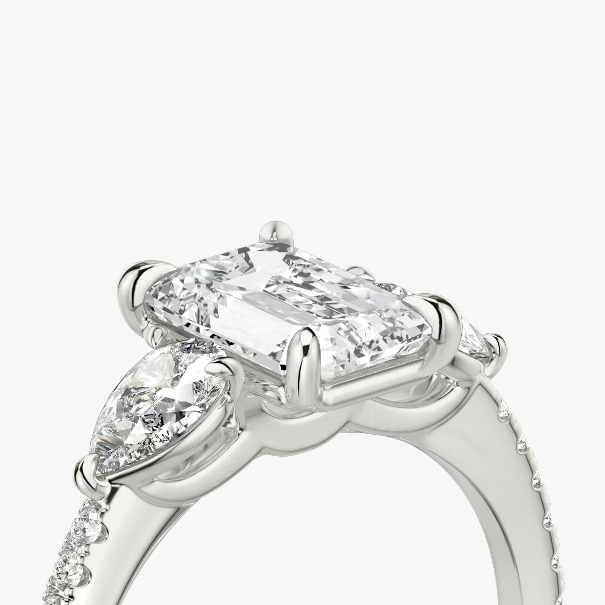 The Three Stone | Emerald | 18k | White Gold | bandAccent: Pavé | sideStoneCarat: 0.25ct | sideStoneShape: Pear | diamondOrientation: vertical | caratWeight: other