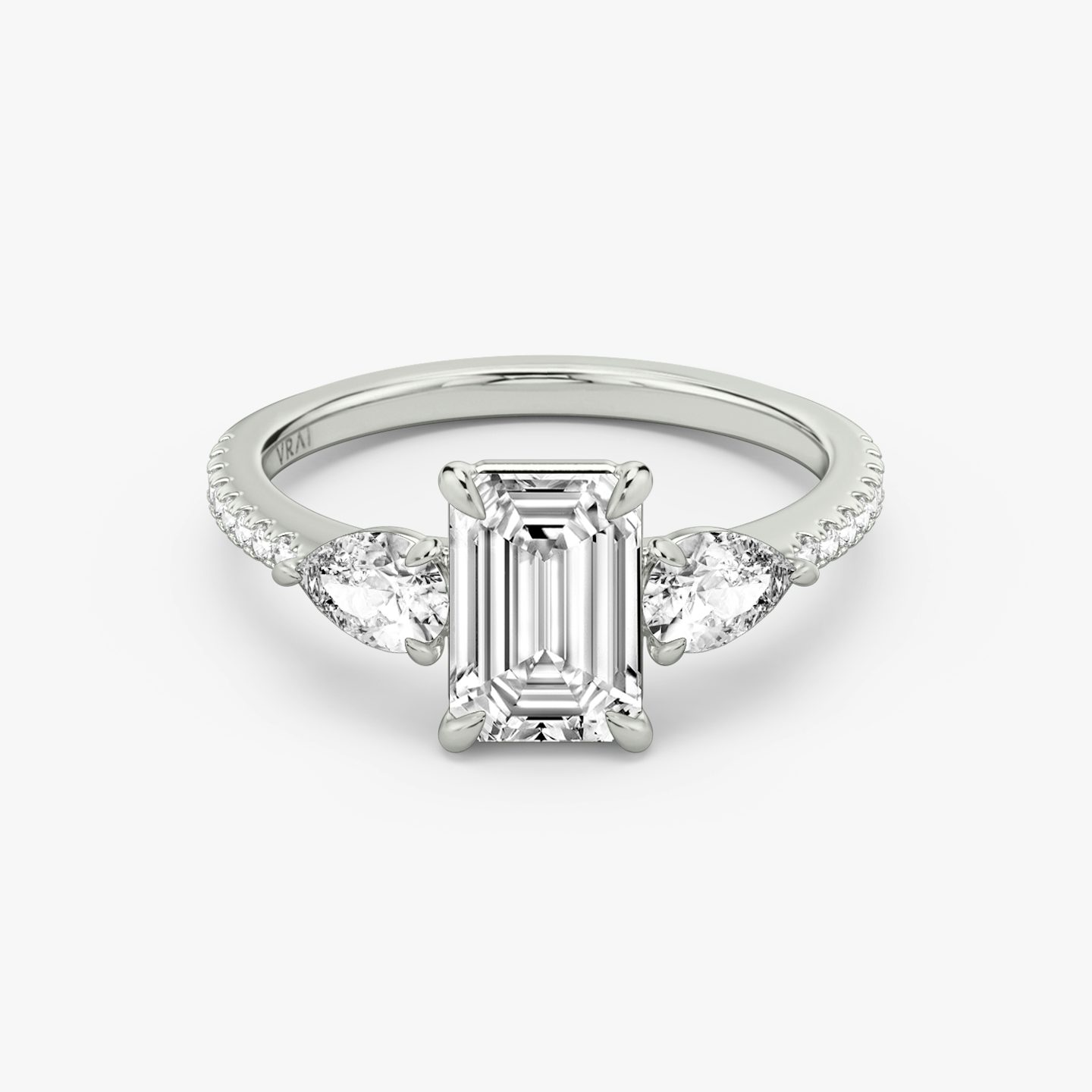 The Three Stone | Emerald | Platinum | bandAccent: Pavé | sideStoneCarat: 0.25ct | sideStoneShape: Pear | diamondOrientation: vertical | caratWeight: other