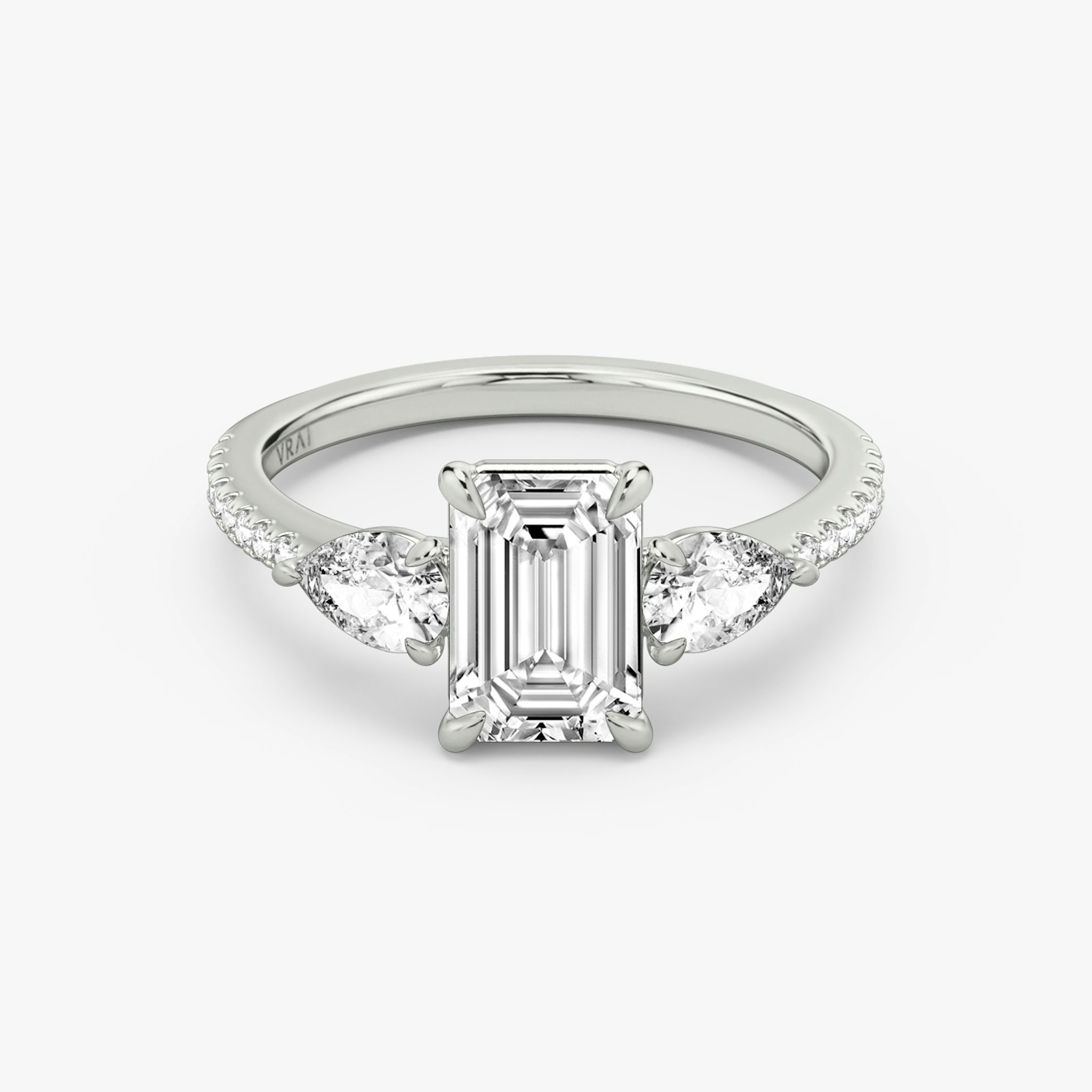 The Three Stone | Emerald | 18k | White Gold | bandAccent: Pavé | sideStoneCarat: 0.25ct | sideStoneShape: Pear | diamondOrientation: vertical | caratWeight: other