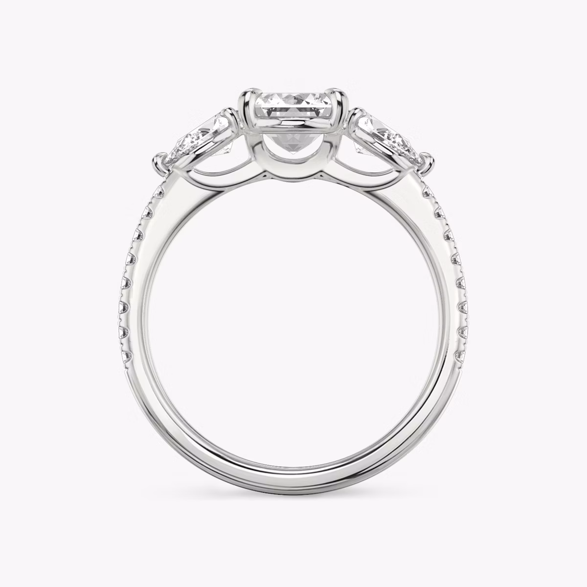 The Three Stone | Emerald | Platinum | bandAccent: Pavé | sideStoneCarat: 0.25ct | sideStoneShape: Pear | diamondOrientation: vertical | caratWeight: other
