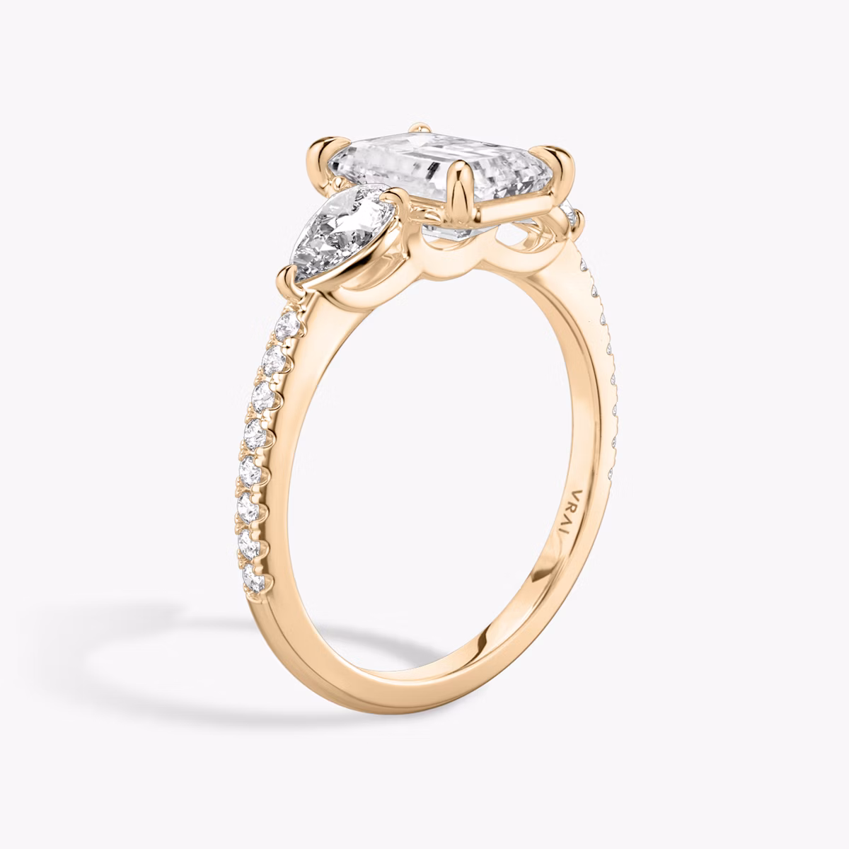 The Three Stone | Emerald | 14k | Rose Gold | bandAccent: Pavé | sideStoneCarat: 0.25ct | sideStoneShape: Pear | diamondOrientation: vertical | caratWeight: other
