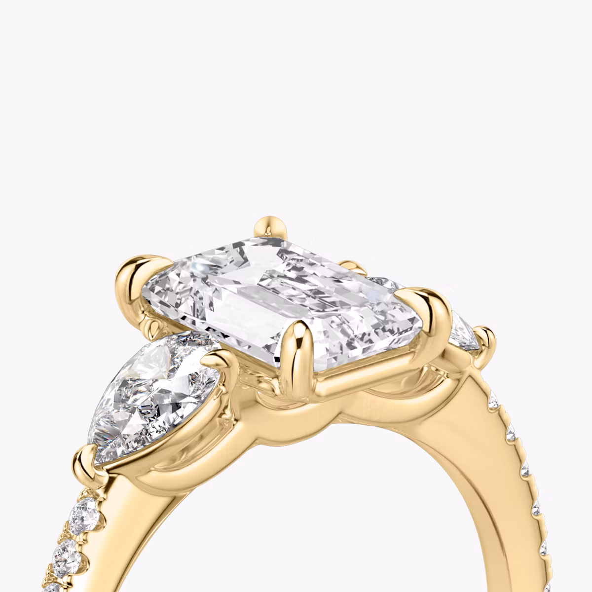 The Three Stone | Emerald | 18k | Yellow Gold | bandAccent: Pavé | sideStoneCarat: 0.25ct | sideStoneShape: Pear | diamondOrientation: vertical | caratWeight: other