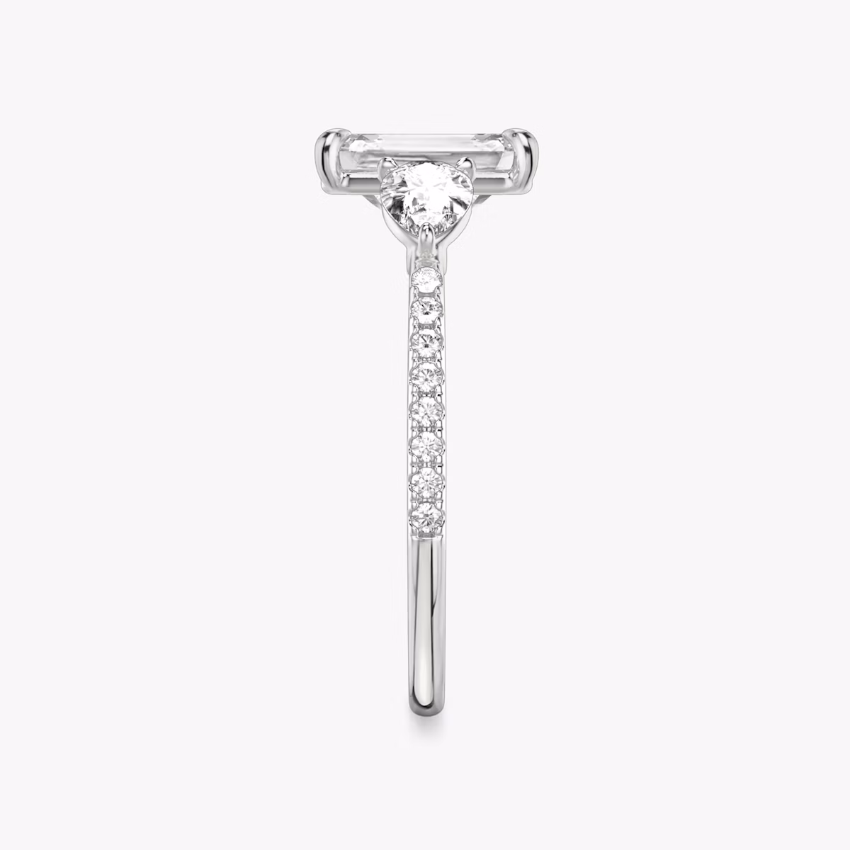 The Three Stone | Emerald | Platinum | bandAccent: Pavé | sideStoneCarat: 0.25ct | sideStoneShape: Pear | diamondOrientation: vertical | caratWeight: other
