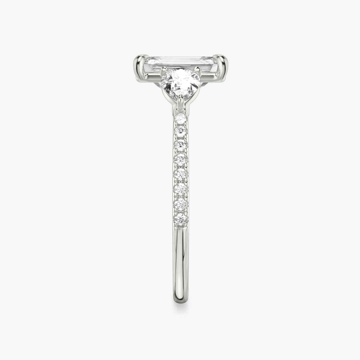 The Three Stone | Emerald | Platinum | bandAccent: Pavé | sideStoneCarat: 0.25ct | sideStoneShape: Pear | diamondOrientation: vertical | caratWeight: other