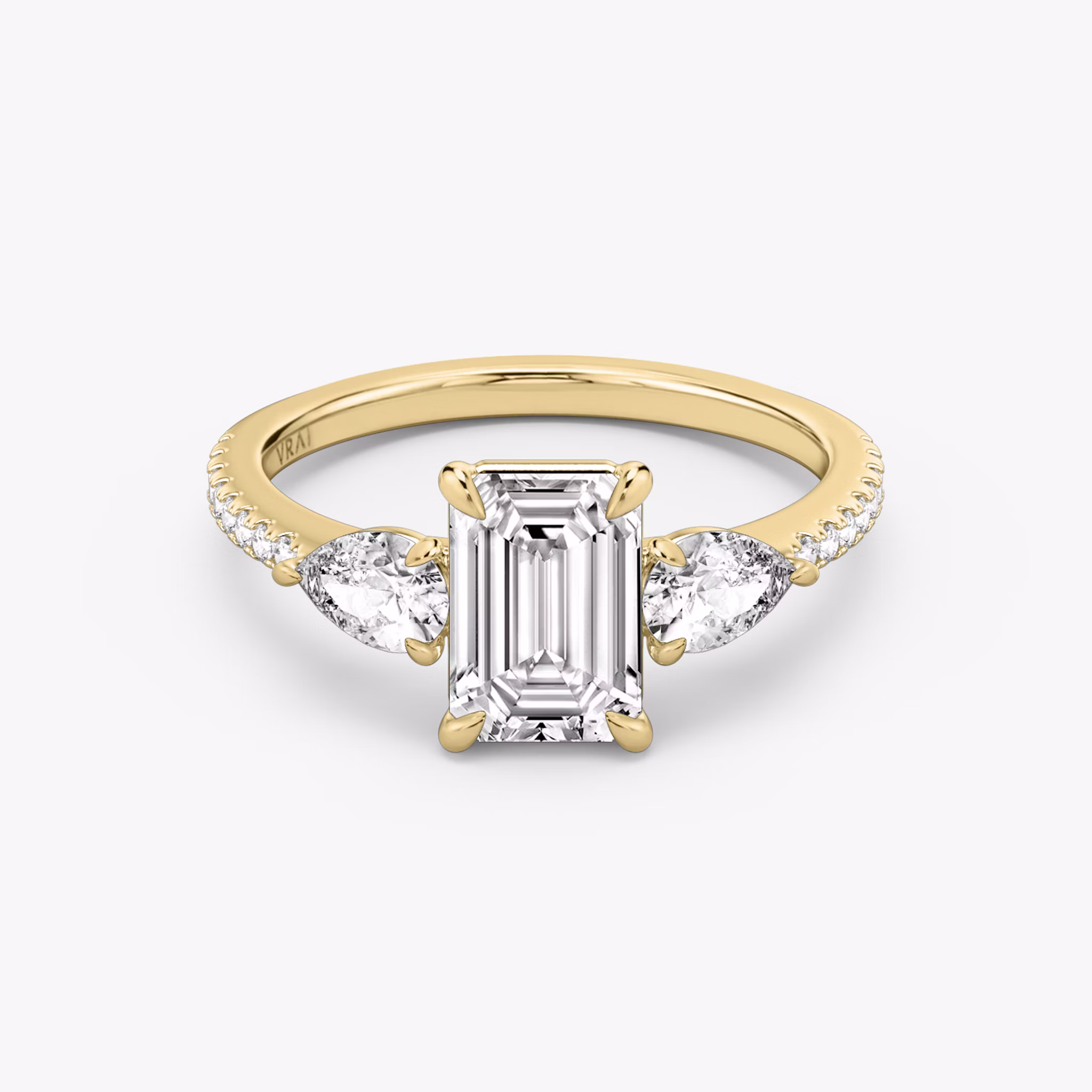 The Three Stone | Emerald | 18k | Yellow Gold | bandAccent: Pavé | sideStoneCarat: 0.25ct | sideStoneShape: Pear | diamondOrientation: vertical | caratWeight: other