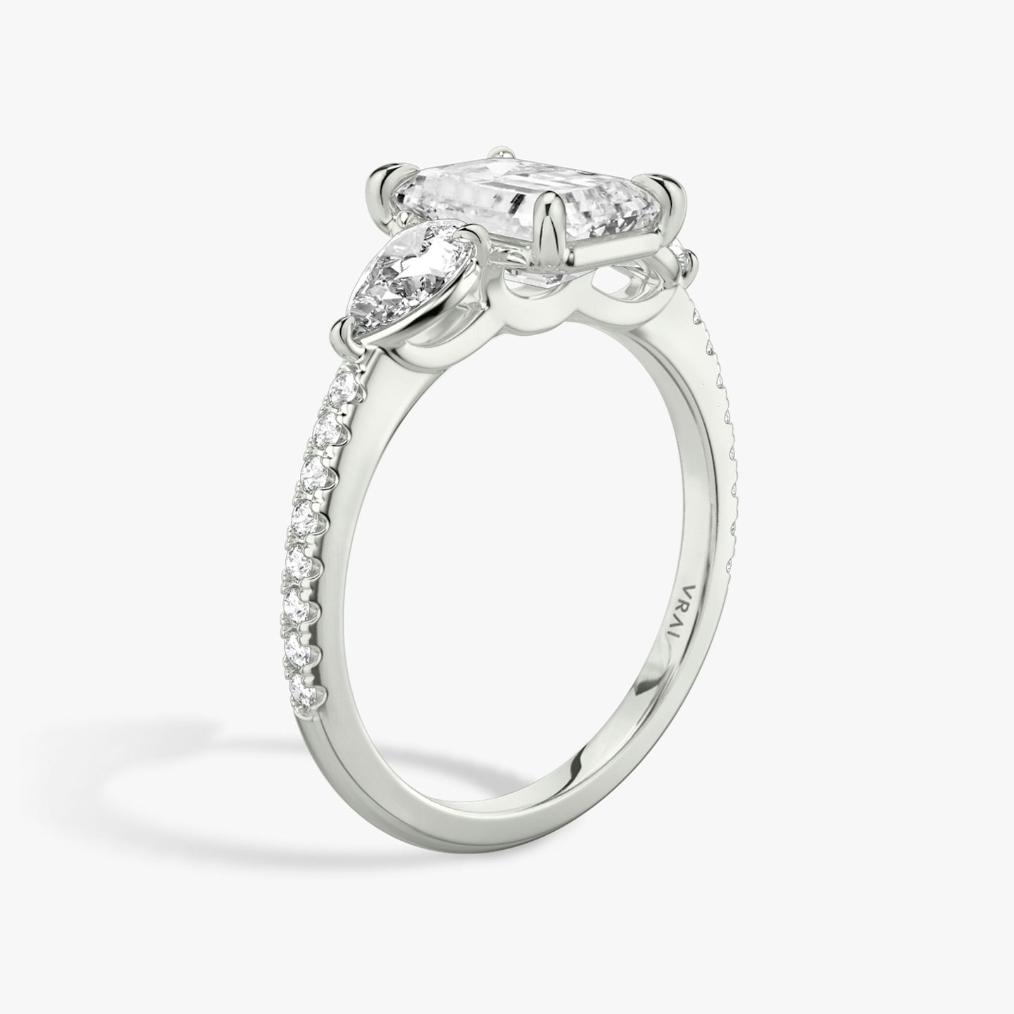 The Three Stone | Emerald | Platinum | bandAccent: Pavé | sideStoneCarat: 0.25ct | sideStoneShape: Pear | diamondOrientation: vertical | caratWeight: other