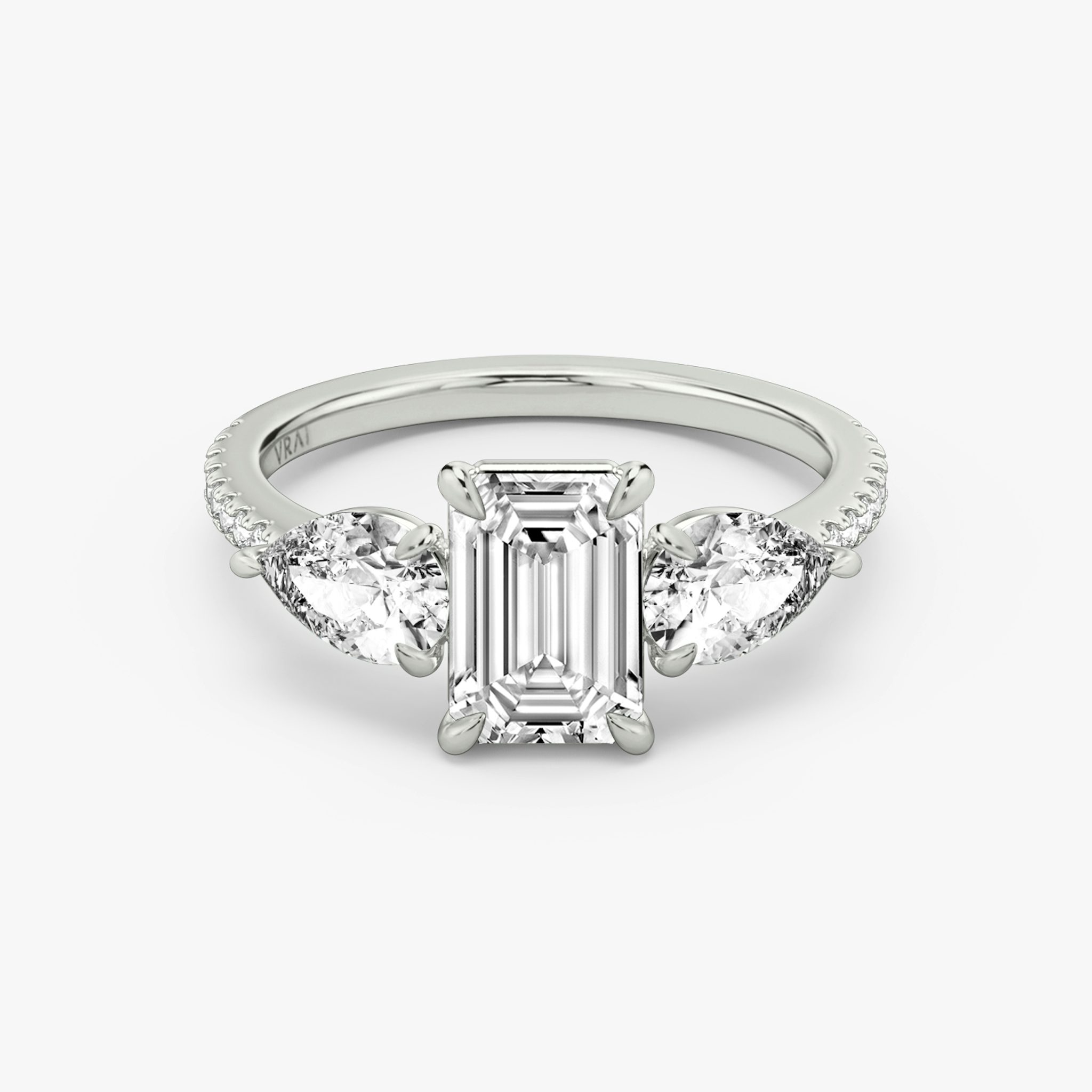 The Three Stone | Emerald | Platinum | bandAccent: Pavé | sideStoneCarat: 0.50ct | sideStoneShape: Pear | diamondOrientation: vertical | caratWeight: other