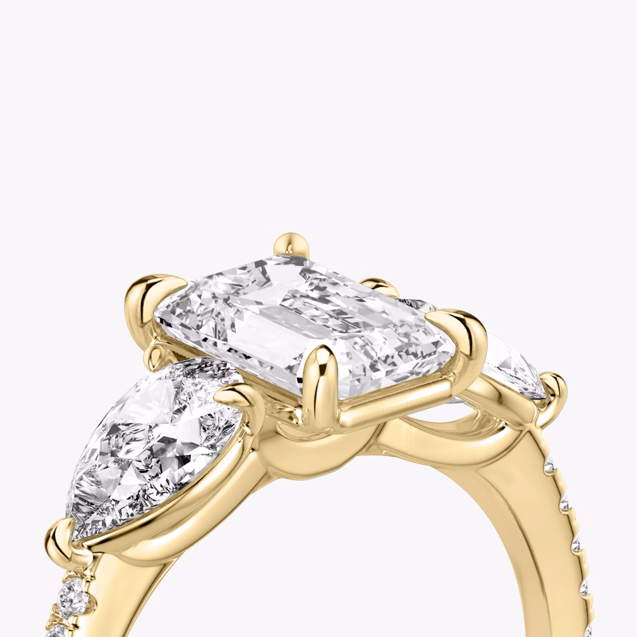 The Three Stone | Emerald | 18k | Yellow Gold | bandAccent: Pavé | sideStoneCarat: 0.50ct | sideStoneShape: Pear | diamondOrientation: vertical | caratWeight: other