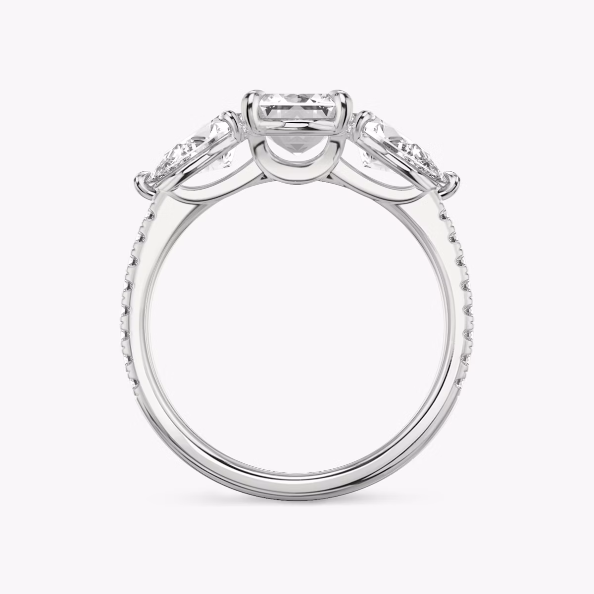 The Three Stone | Emerald | Platinum | bandAccent: Pavé | sideStoneCarat: 0.50ct | sideStoneShape: Pear | diamondOrientation: vertical | caratWeight: other
