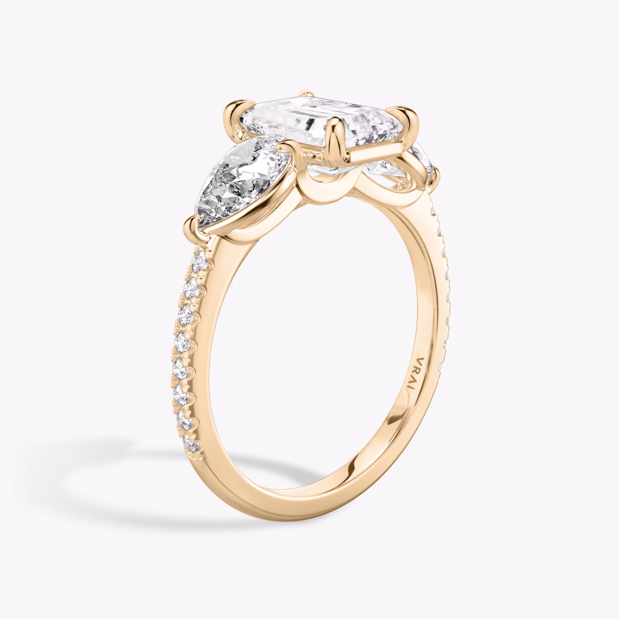 The Three Stone | Emerald | 14k | Rose Gold | bandAccent: Pavé | sideStoneCarat: 0.50ct | sideStoneShape: Pear | diamondOrientation: vertical | caratWeight: other