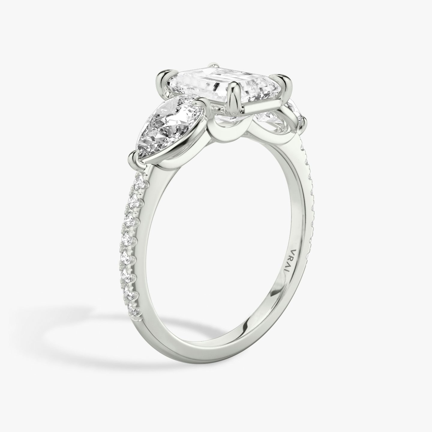 The Three Stone | Emerald | Platinum | bandAccent: Pavé | sideStoneCarat: 0.50ct | sideStoneShape: Pear | diamondOrientation: vertical | caratWeight: other