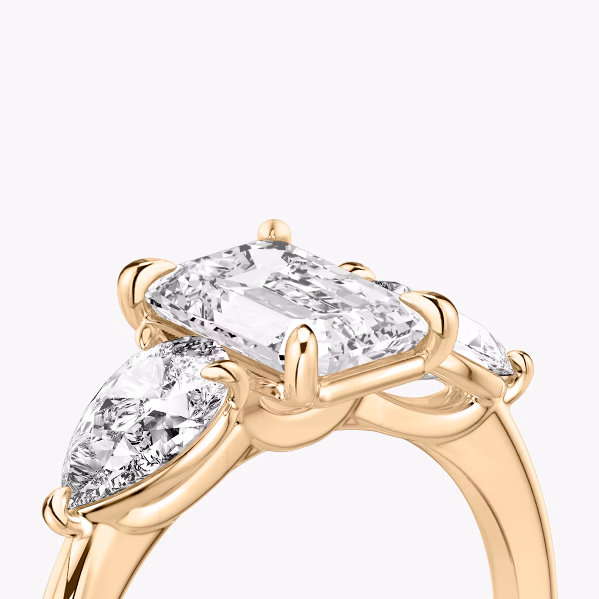 The Three Stone | Emerald | 14k | Rose Gold | bandAccent: Plain | sideStoneCarat: 0.50ct | sideStoneShape: Pear | diamondOrientation: vertical | caratWeight: other