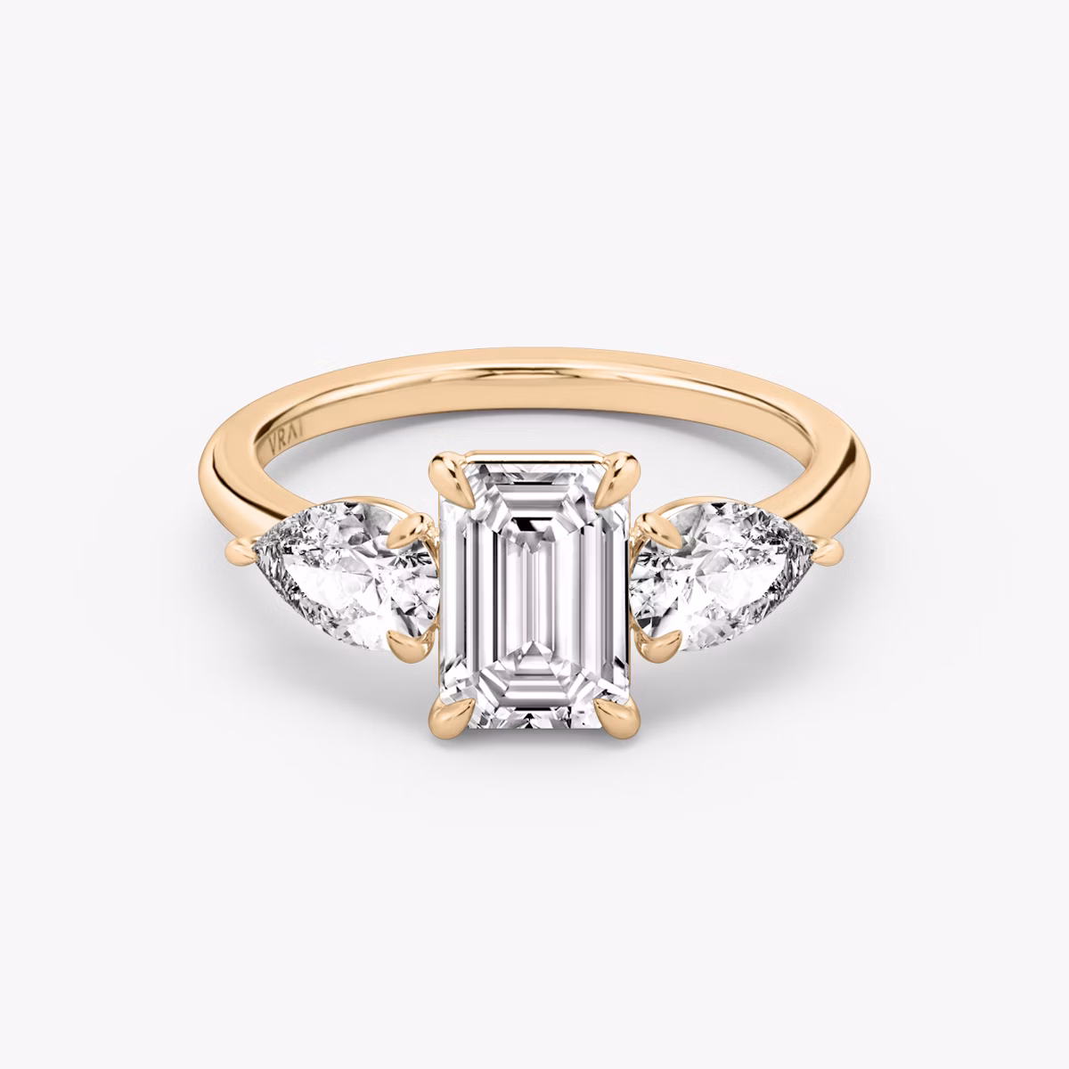 The Three Stone | Emerald | 14k | Rose Gold | bandAccent: Plain | sideStoneCarat: 0.50ct | sideStoneShape: Pear | diamondOrientation: vertical | caratWeight: other