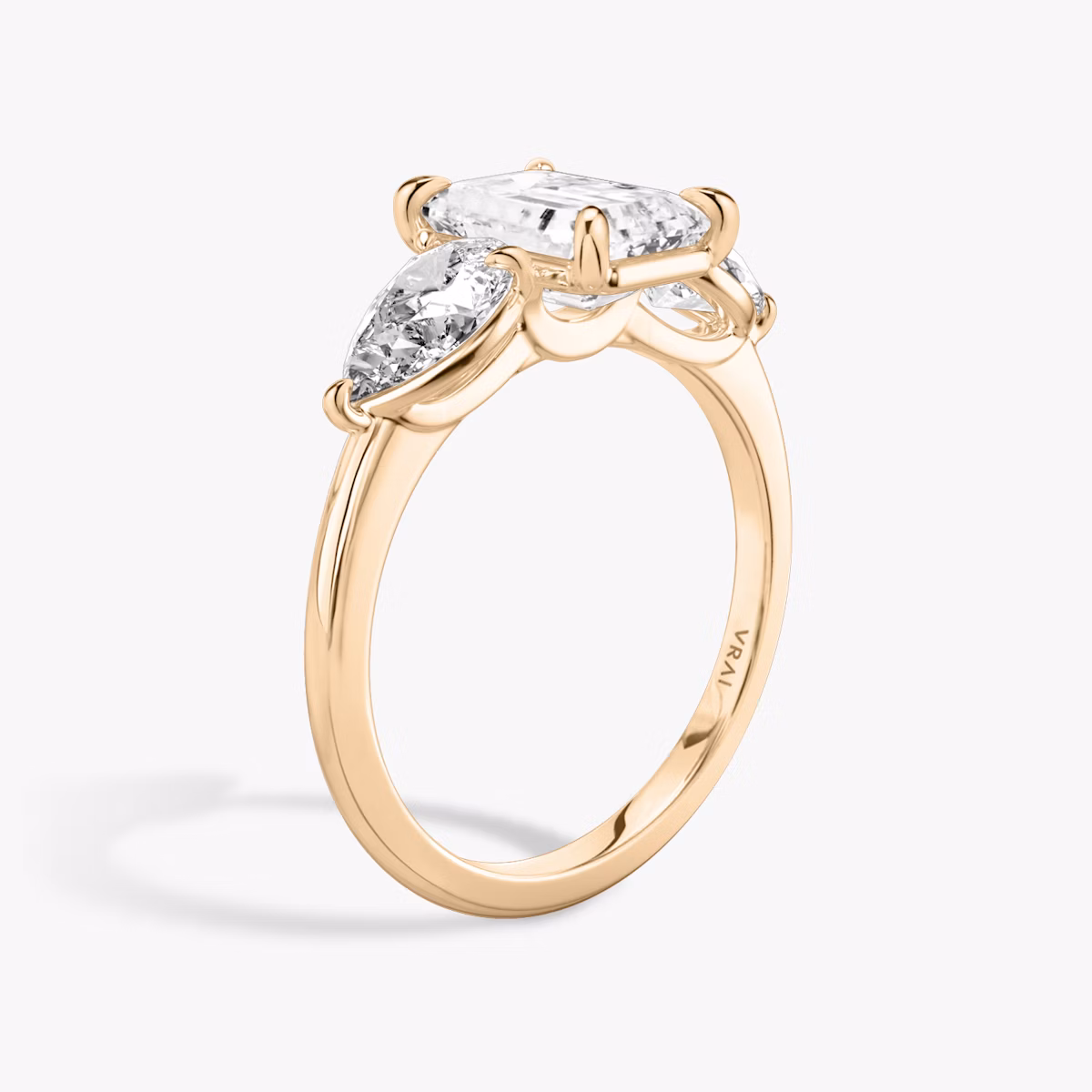 The Three Stone | Emerald | 14k | Rose Gold | bandAccent: Plain | sideStoneCarat: 0.50ct | sideStoneShape: Pear | diamondOrientation: vertical | caratWeight: other