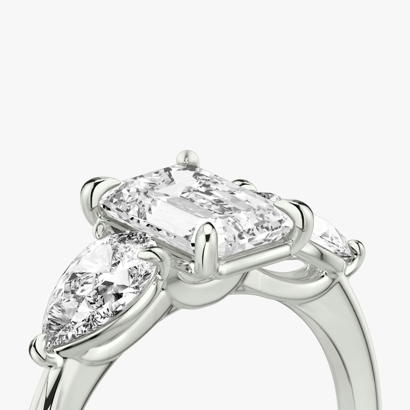 The Three Stone | Emerald | Platinum | bandAccent: Plain | sideStoneCarat: 0.50ct | sideStoneShape: Pear | diamondOrientation: vertical | caratWeight: other