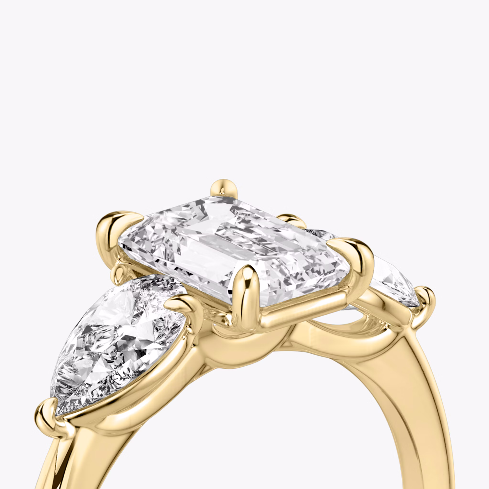 The Three Stone | Emerald | 18k | Yellow Gold | bandAccent: Plain | sideStoneCarat: 0.50ct | sideStoneShape: Pear | diamondOrientation: vertical | caratWeight: other