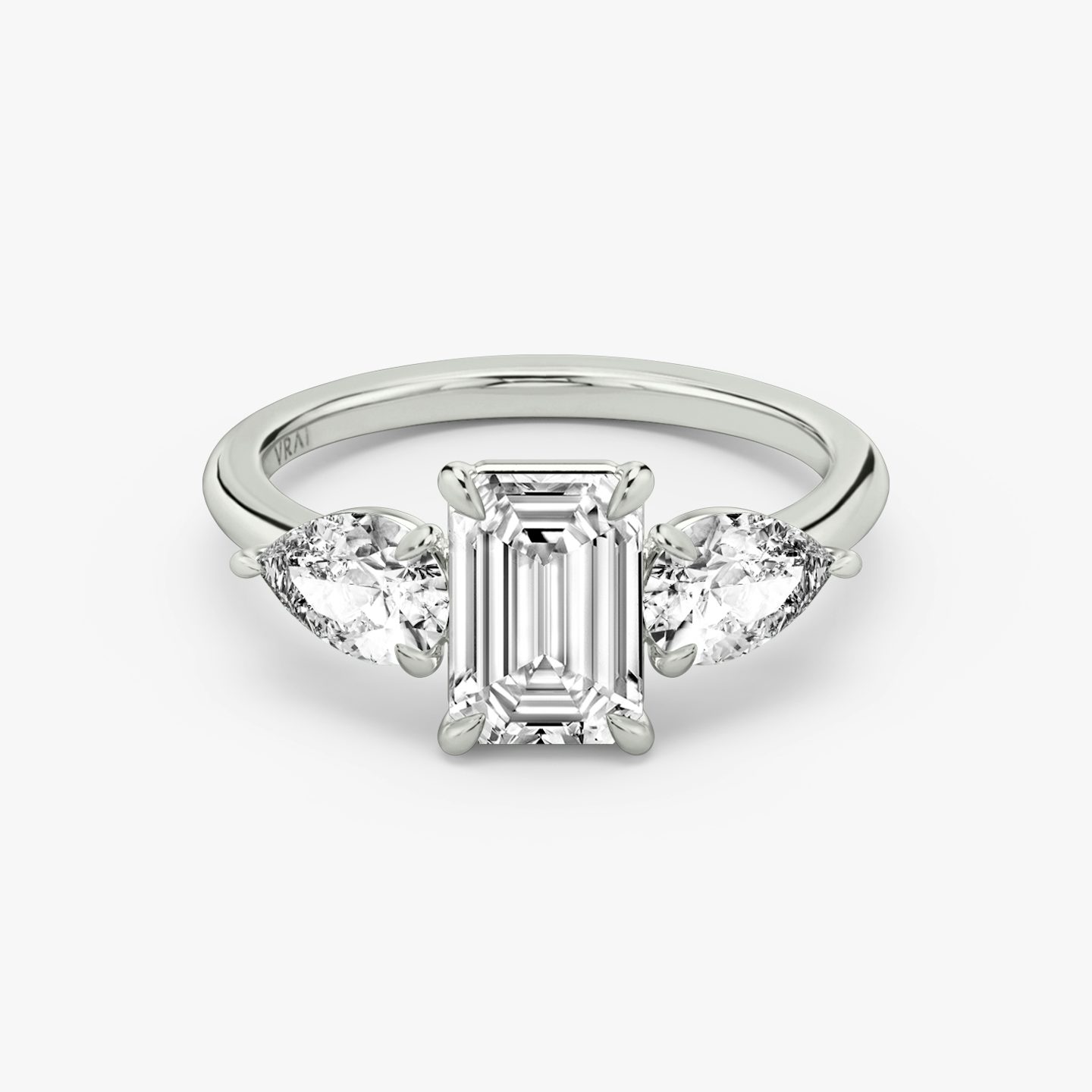 The Three Stone | Emerald | Platinum | bandAccent: Plain | sideStoneCarat: 0.50ct | sideStoneShape: Pear | diamondOrientation: vertical | caratWeight: other