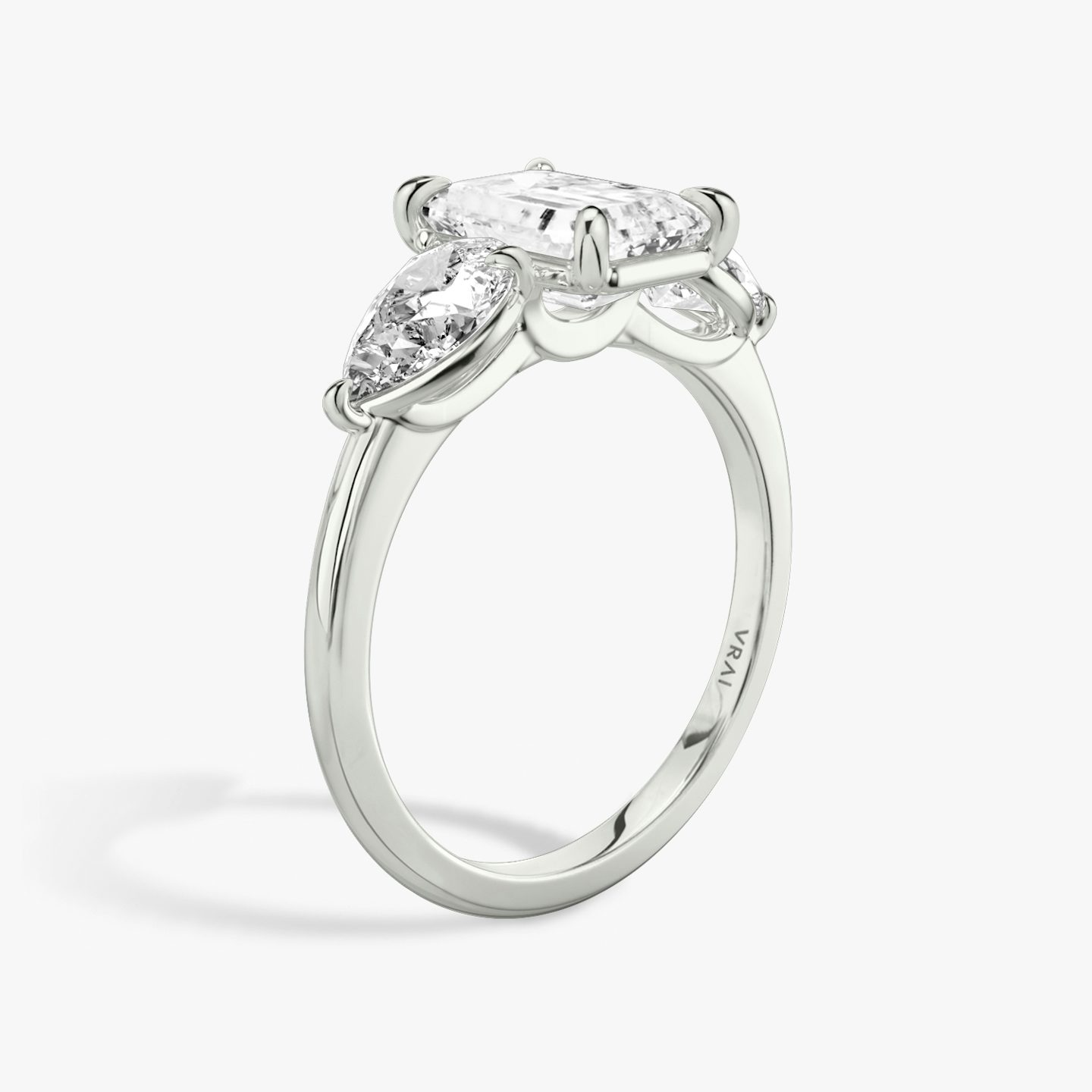 The Three Stone | Emerald | Platinum | bandAccent: Plain | sideStoneCarat: 0.50ct | sideStoneShape: Pear | diamondOrientation: vertical | caratWeight: other