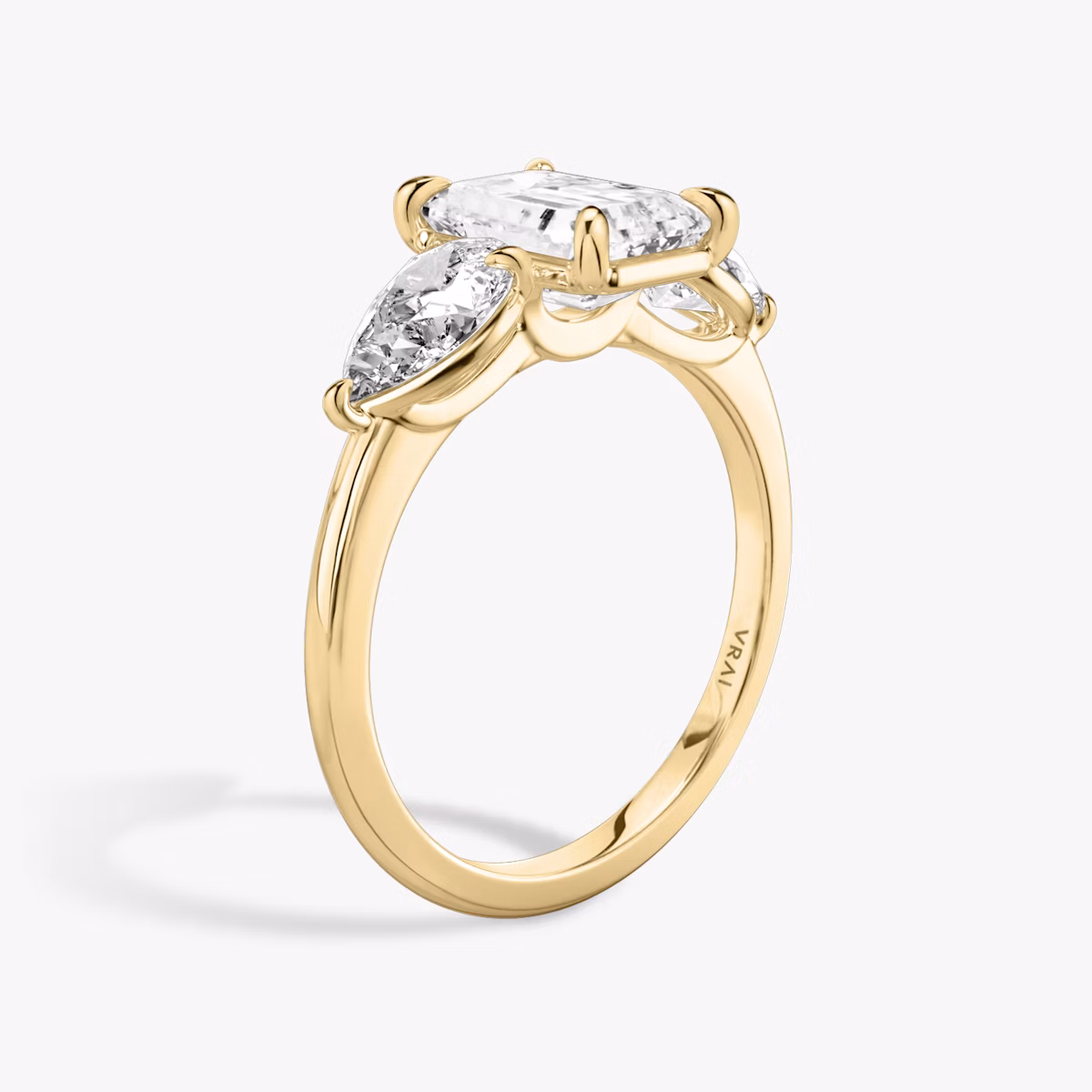 The Three Stone | Emerald | 18k | Yellow Gold | bandAccent: Plain | sideStoneCarat: 0.50ct | sideStoneShape: Pear | diamondOrientation: vertical | caratWeight: other