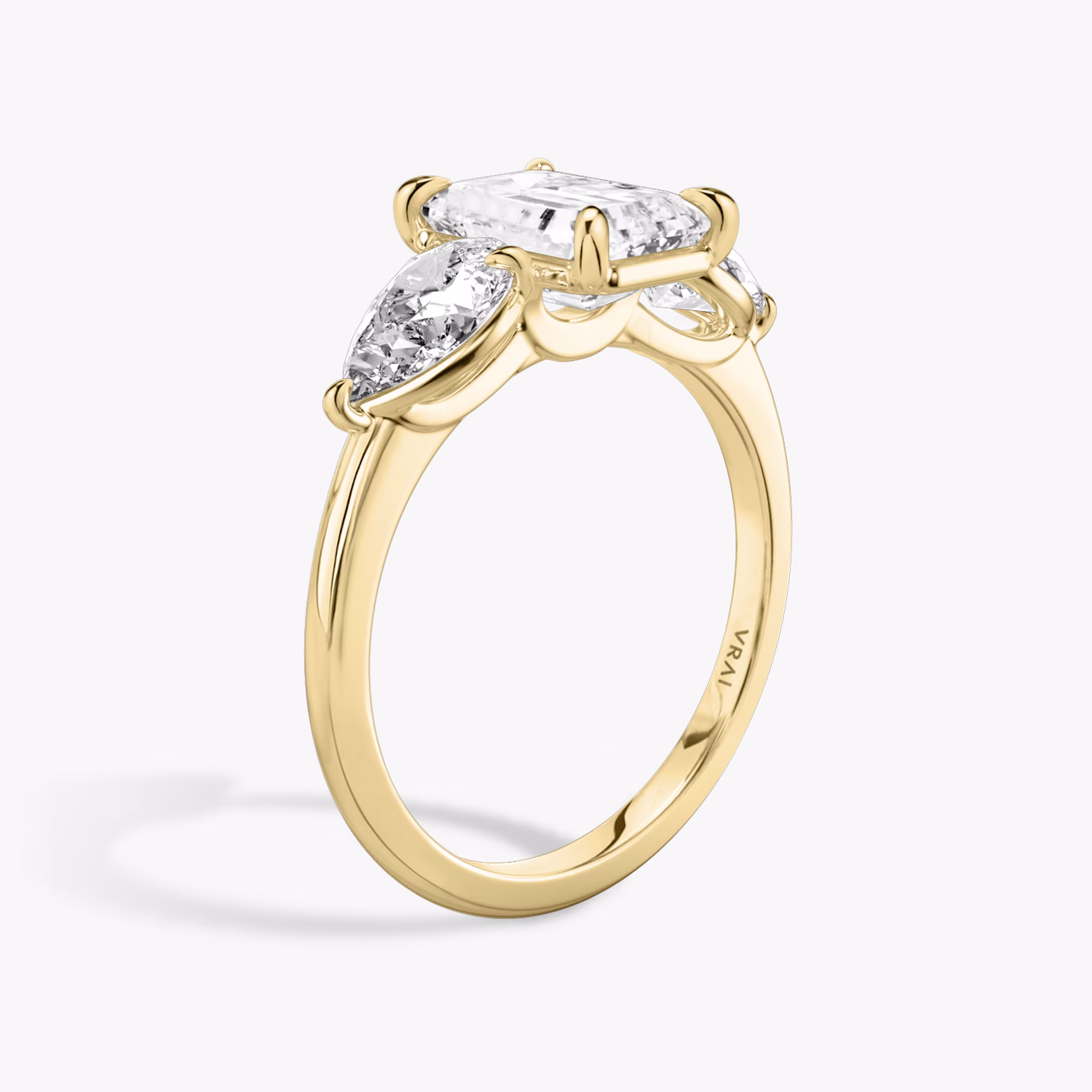 The Three Stone | Emerald | 18k | Yellow Gold | bandAccent: Plain | sideStoneCarat: 0.50ct | sideStoneShape: Pear | diamondOrientation: vertical | caratWeight: other