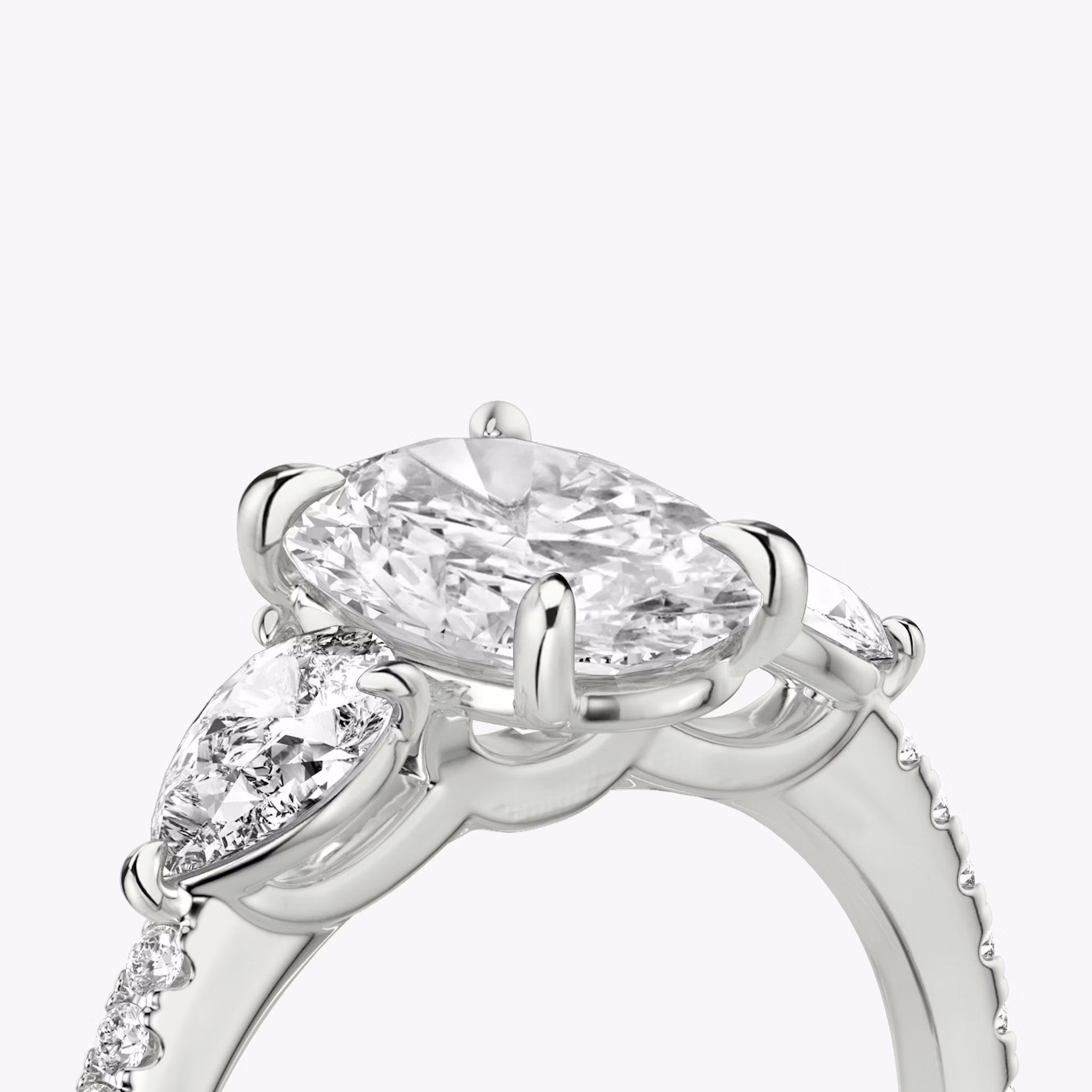 The Three Stone | Oval | 18k | White Gold | bandAccent: Pavé | sideStoneCarat: 0.25ct | sideStoneShape: Pear | diamondOrientation: vertical | caratWeight: other