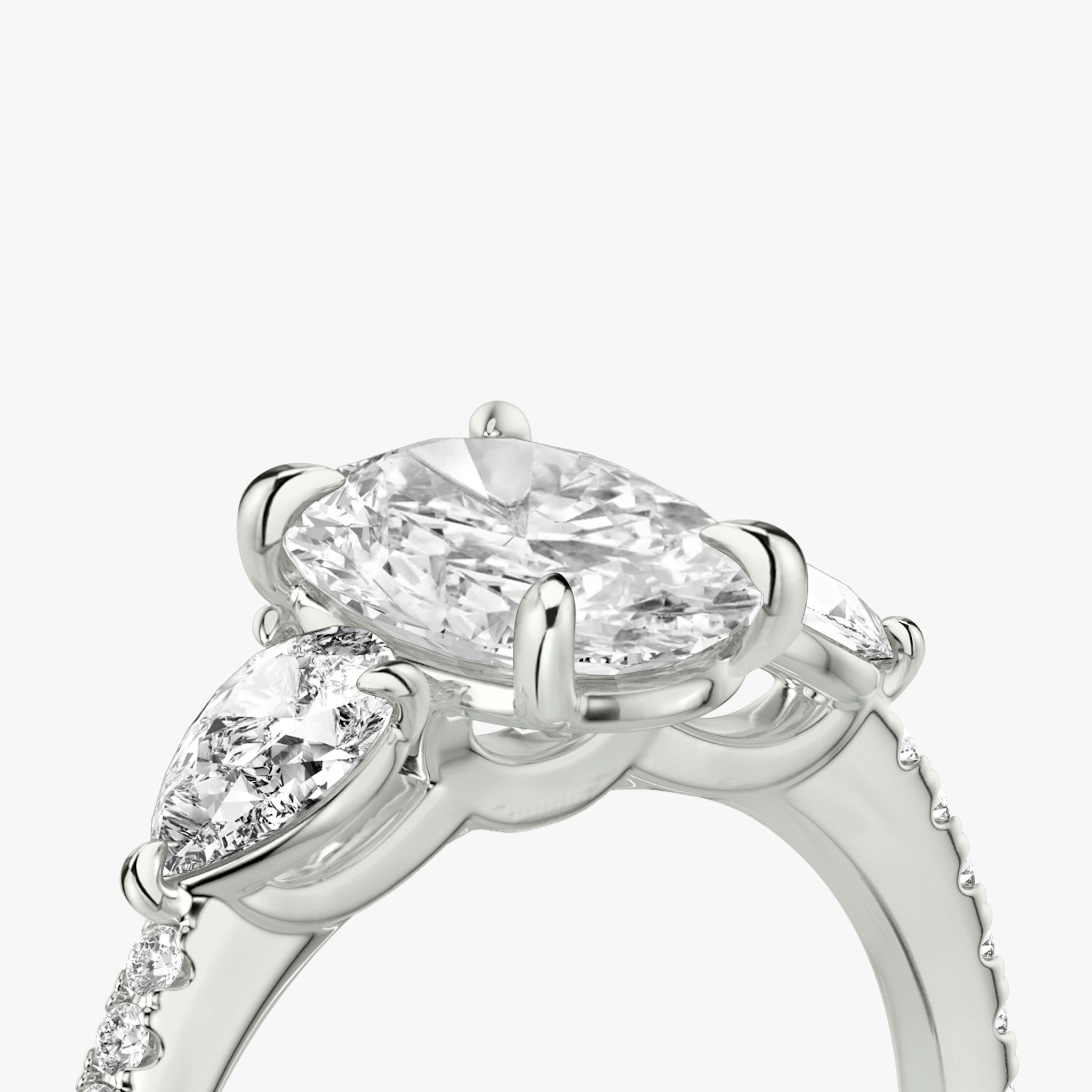 The Three Stone | Oval | 18k | White Gold | bandAccent: Pavé | sideStoneCarat: 0.25ct | sideStoneShape: Pear | diamondOrientation: vertical | caratWeight: other