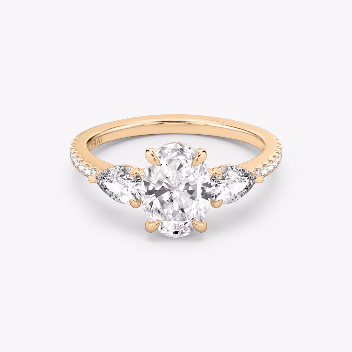 The Three Stone | Oval | 14k | Rose Gold | bandAccent: Pavé | sideStoneCarat: 0.25ct | sideStoneShape: Pear | diamondOrientation: vertical | caratWeight: other