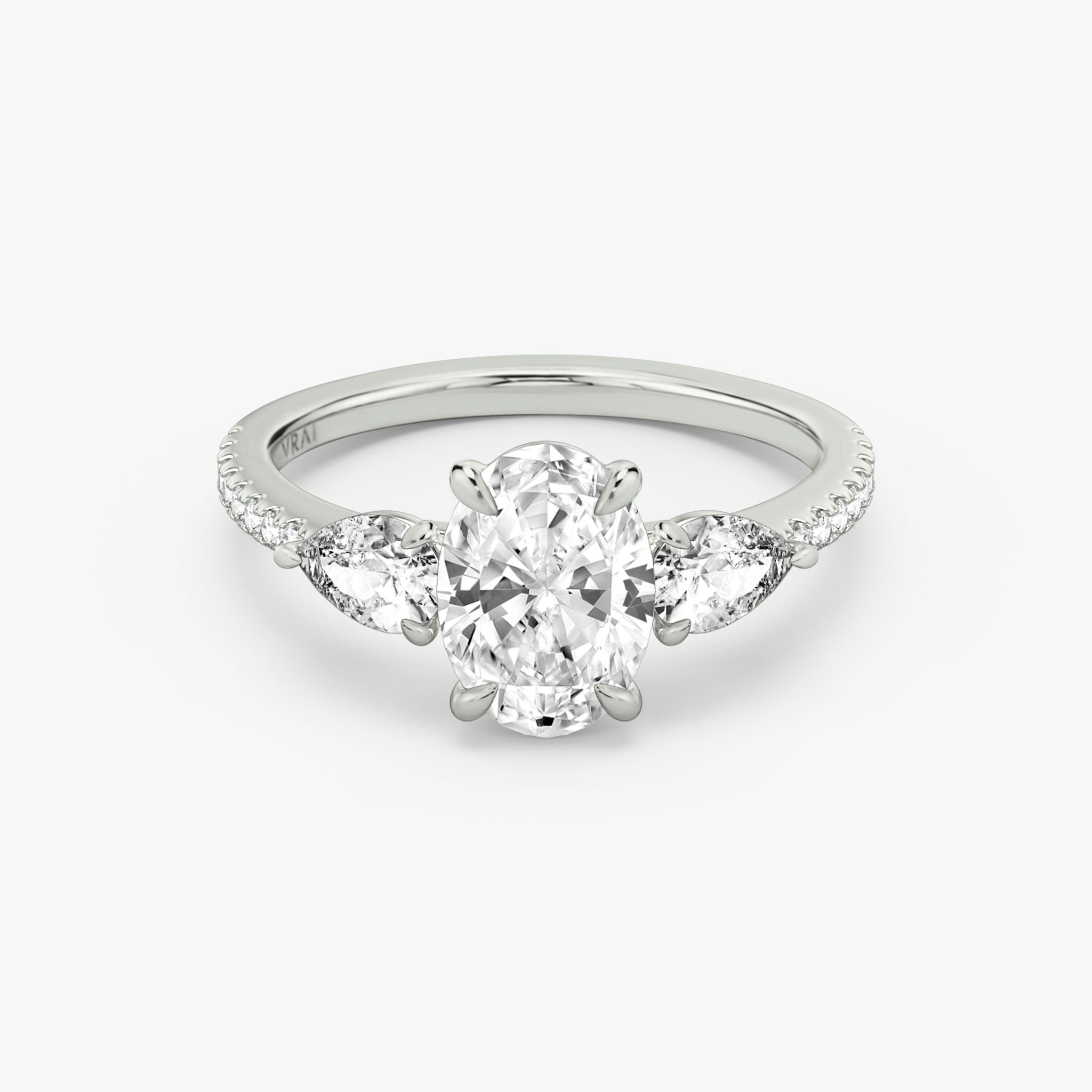 The Three Stone | Oval | 18k | White Gold | bandAccent: Pavé | sideStoneCarat: 0.25ct | sideStoneShape: Pear | diamondOrientation: vertical | caratWeight: other