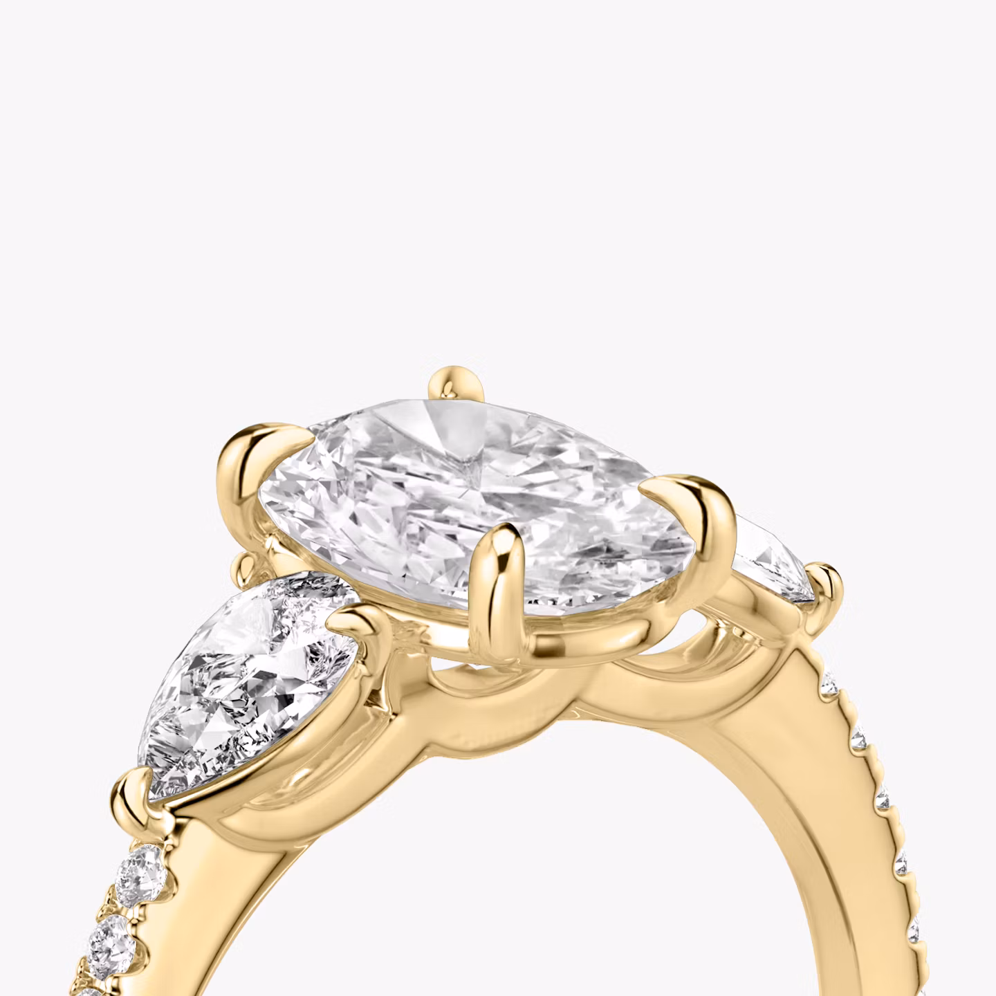 The Three Stone | Oval | 18k | Yellow Gold | bandAccent: Pavé | sideStoneCarat: 0.25ct | sideStoneShape: Pear | diamondOrientation: vertical | caratWeight: other