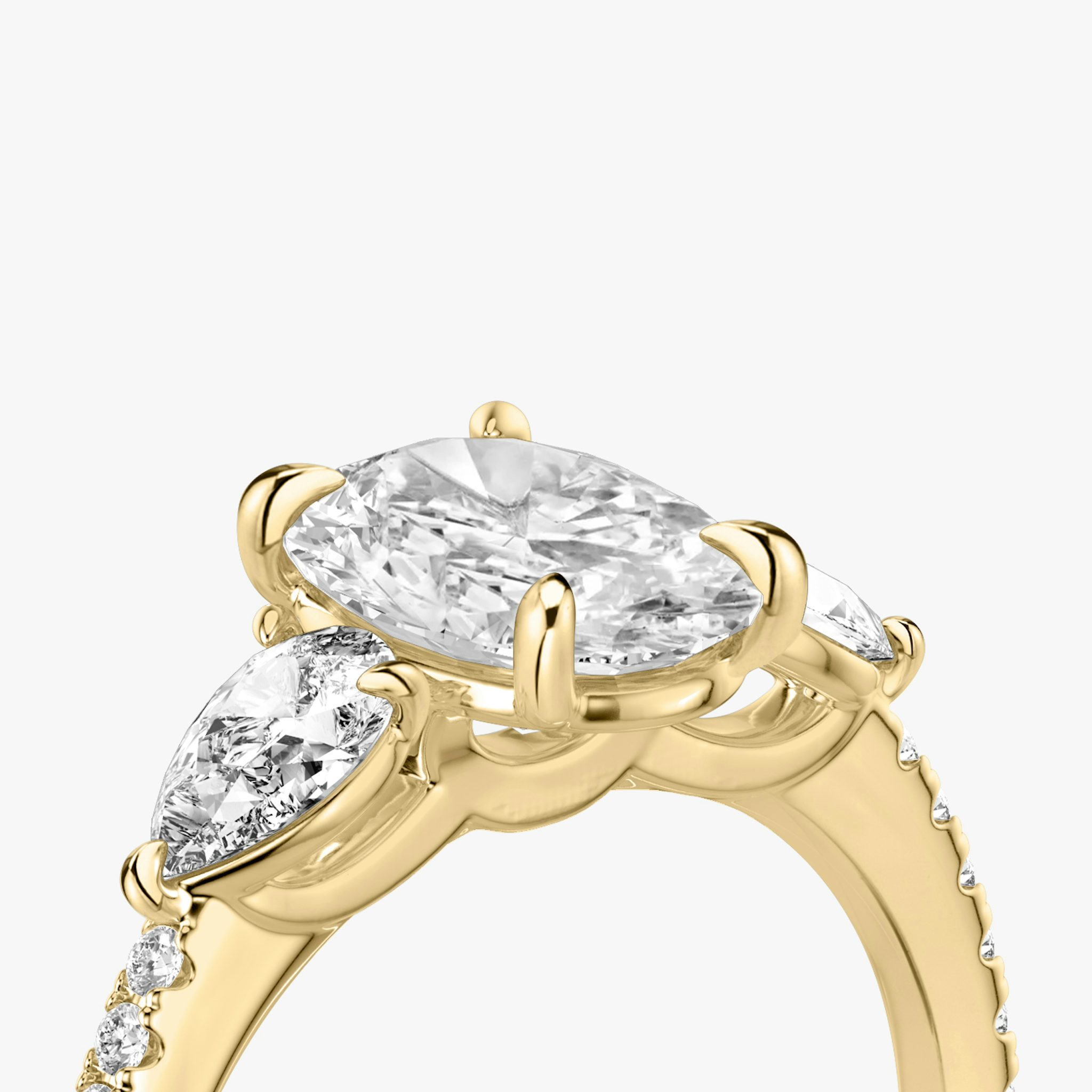 The Three Stone | Oval | 18k | Yellow Gold | bandAccent: Pavé | sideStoneCarat: 0.25ct | sideStoneShape: Pear | diamondOrientation: vertical | caratWeight: other