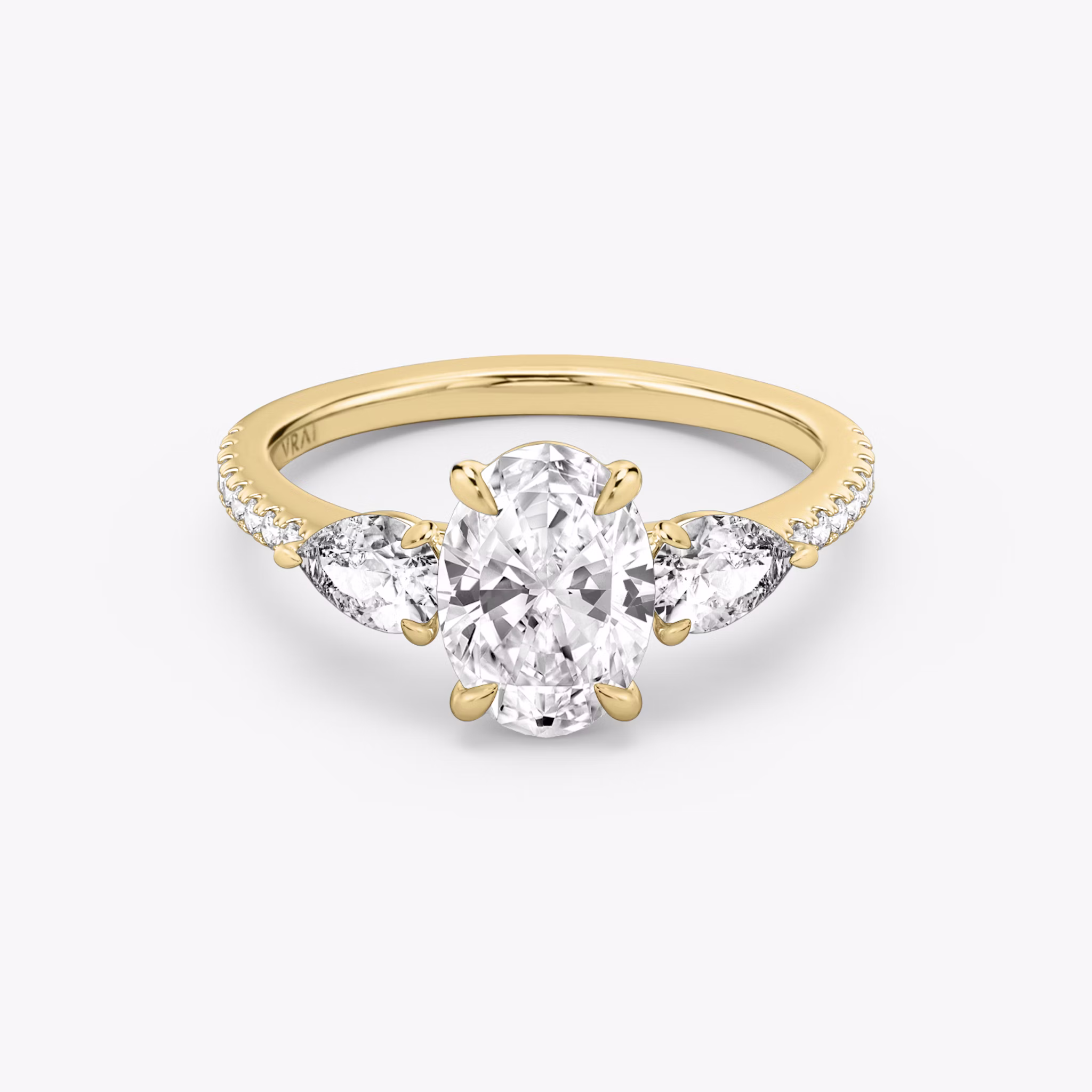 The Three Stone | Oval | 18k | Yellow Gold | bandAccent: Pavé | sideStoneCarat: 0.25ct | sideStoneShape: Pear | diamondOrientation: vertical | caratWeight: other