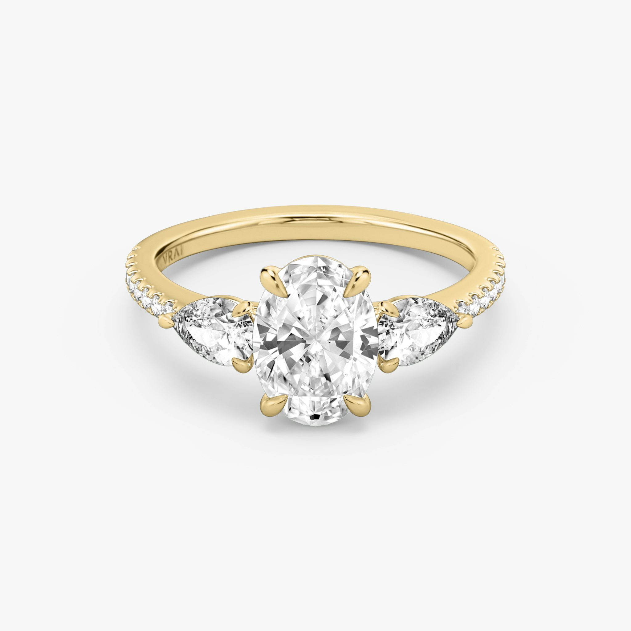The Three Stone | Oval | 18k | Yellow Gold | bandAccent: Pavé | sideStoneCarat: 0.25ct | sideStoneShape: Pear | diamondOrientation: vertical | caratWeight: other