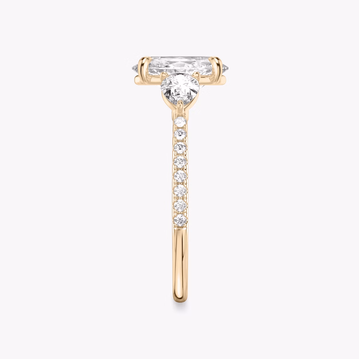 The Three Stone | Oval | 14k | Rose Gold | bandAccent: Pavé | sideStoneCarat: 0.25ct | sideStoneShape: Pear | diamondOrientation: vertical | caratWeight: other