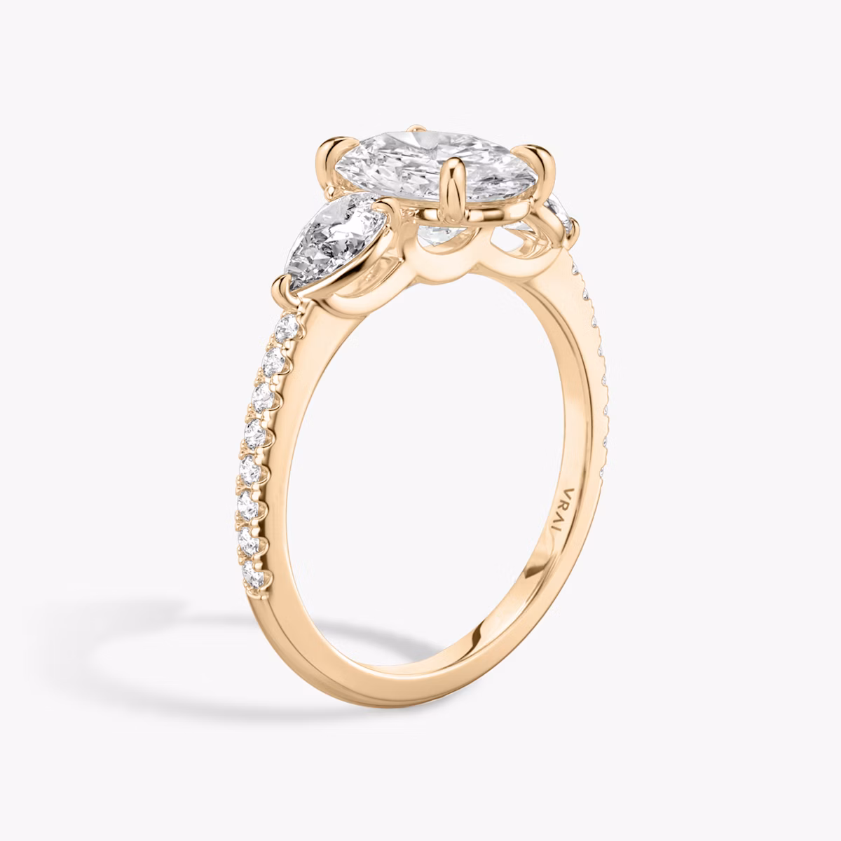 The Three Stone | Oval | 14k | Rose Gold | bandAccent: Pavé | sideStoneCarat: 0.25ct | sideStoneShape: Pear | diamondOrientation: vertical | caratWeight: other