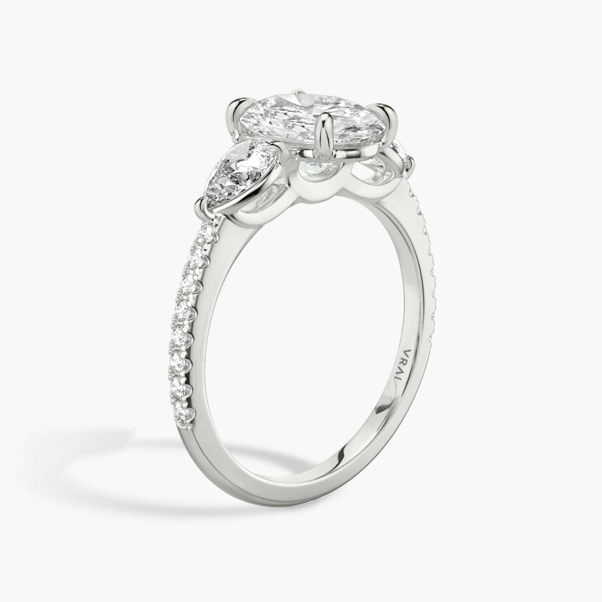 The Three Stone | Oval | 18k | White Gold | bandAccent: Pavé | sideStoneCarat: 0.25ct | sideStoneShape: Pear | diamondOrientation: vertical | caratWeight: other