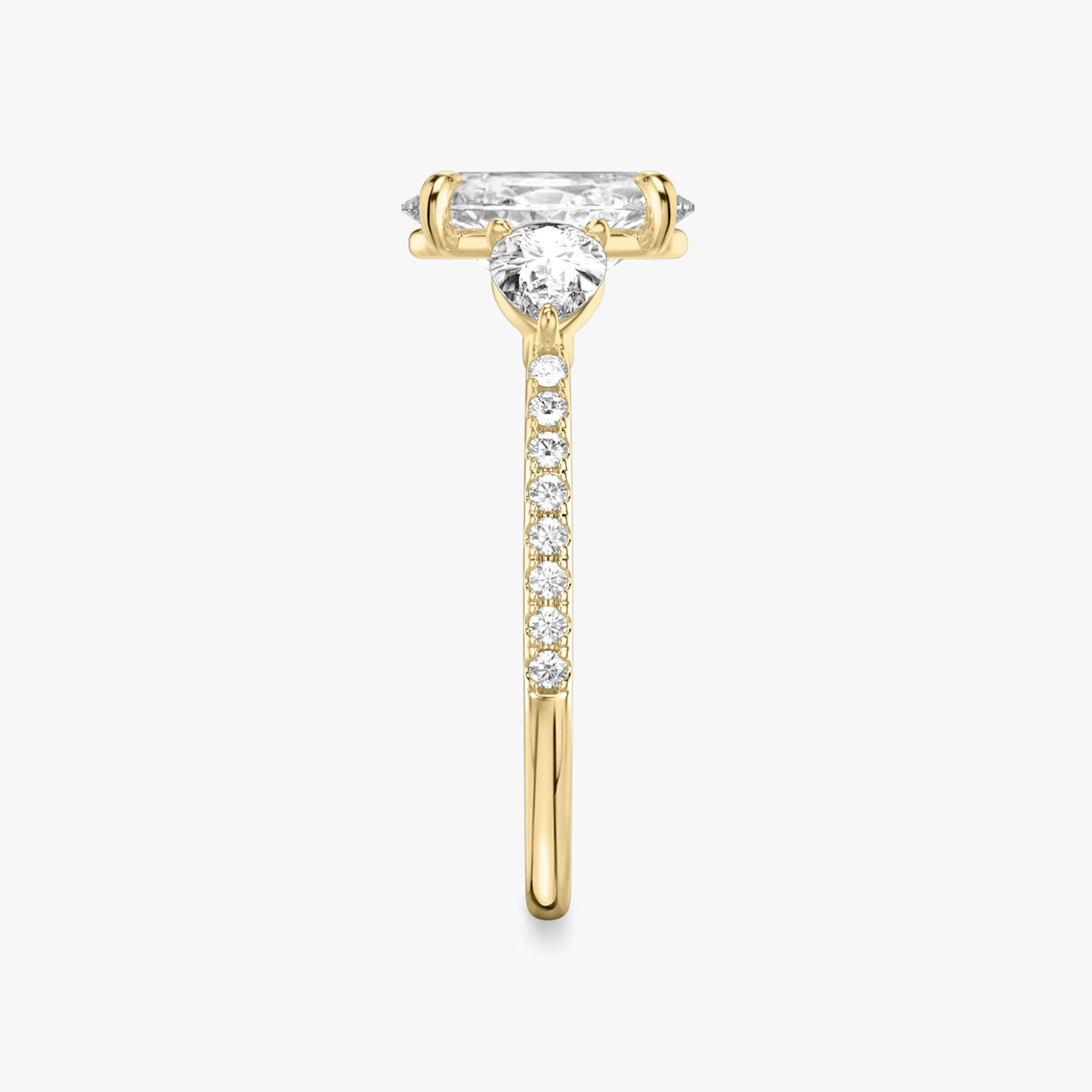 The Three Stone | Oval | 18k | Yellow Gold | bandAccent: Pavé | sideStoneCarat: 0.25ct | sideStoneShape: Pear | diamondOrientation: vertical | caratWeight: other