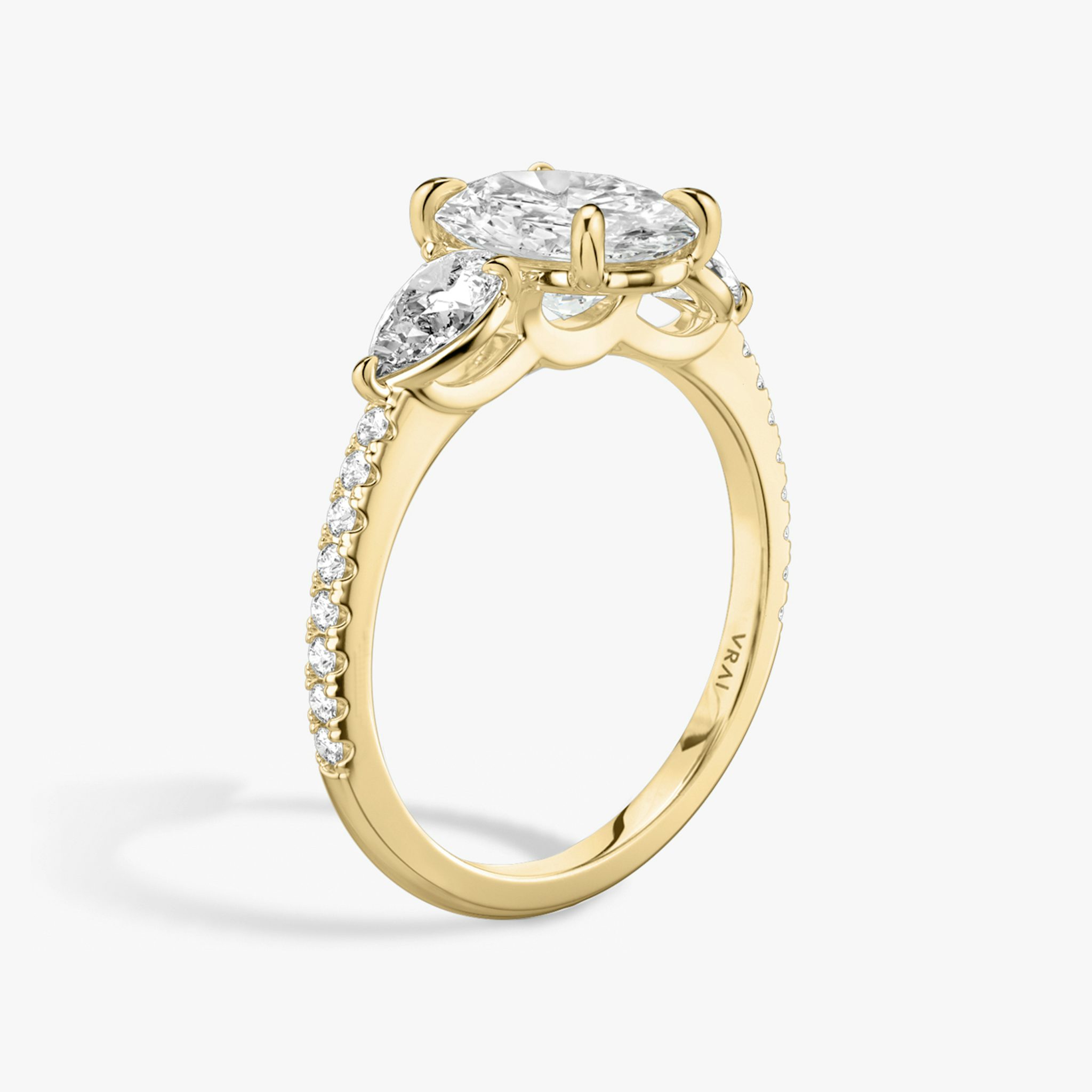 The Three Stone | Oval | 18k | Yellow Gold | bandAccent: Pavé | sideStoneCarat: 0.25ct | sideStoneShape: Pear | diamondOrientation: vertical | caratWeight: other