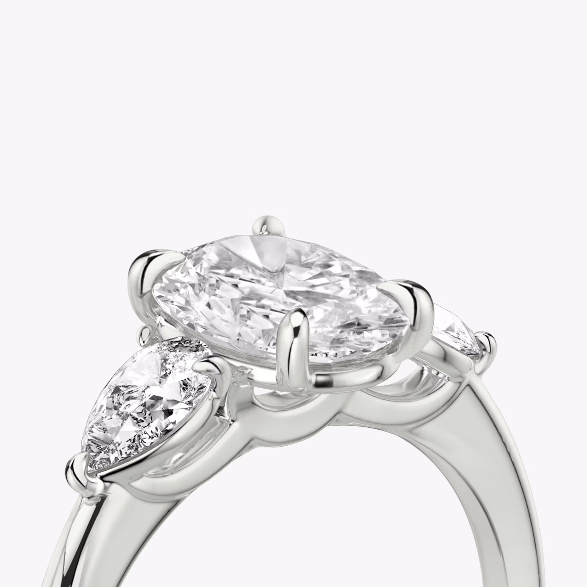 The Three Stone | Oval | Platinum | bandAccent: Plain | sideStoneCarat: 0.25ct | sideStoneShape: Pear | diamondOrientation: vertical | caratWeight: other