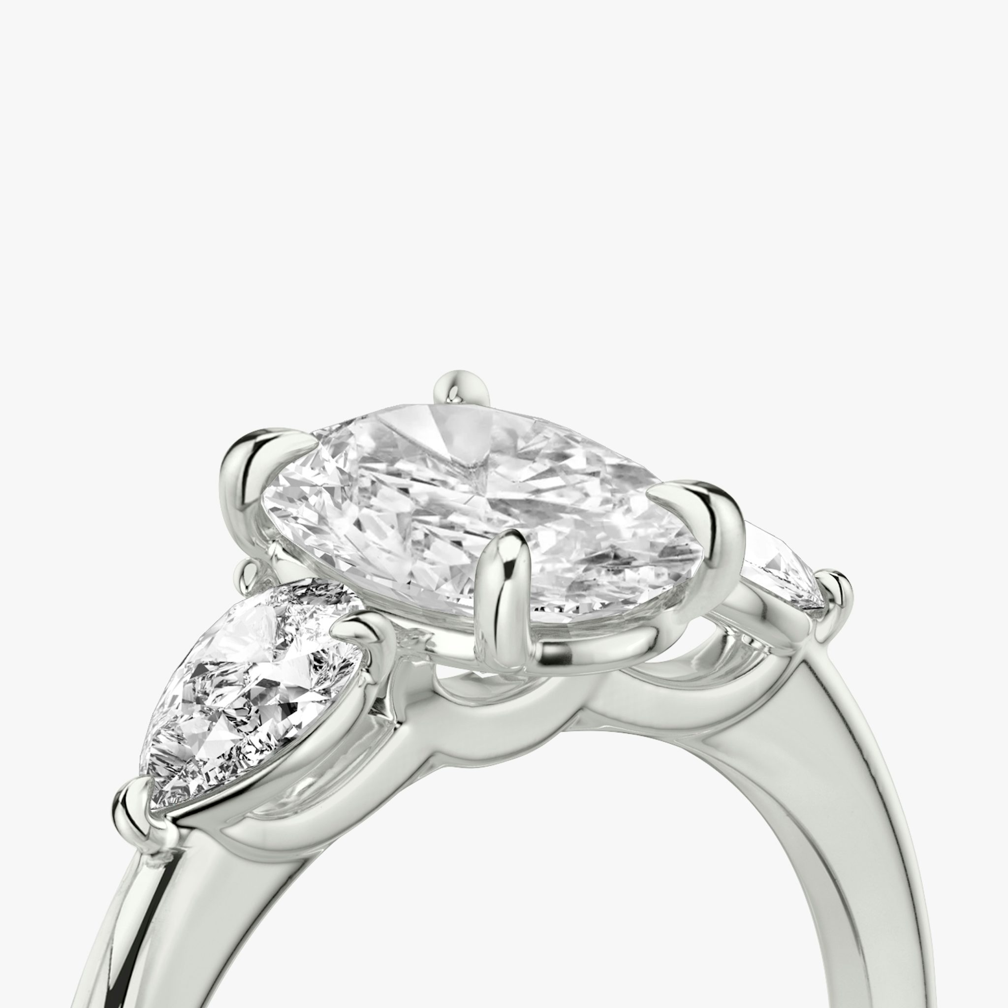 The Three Stone | Oval | Platinum | bandAccent: Plain | sideStoneCarat: 0.25ct | sideStoneShape: Pear | diamondOrientation: vertical | caratWeight: other