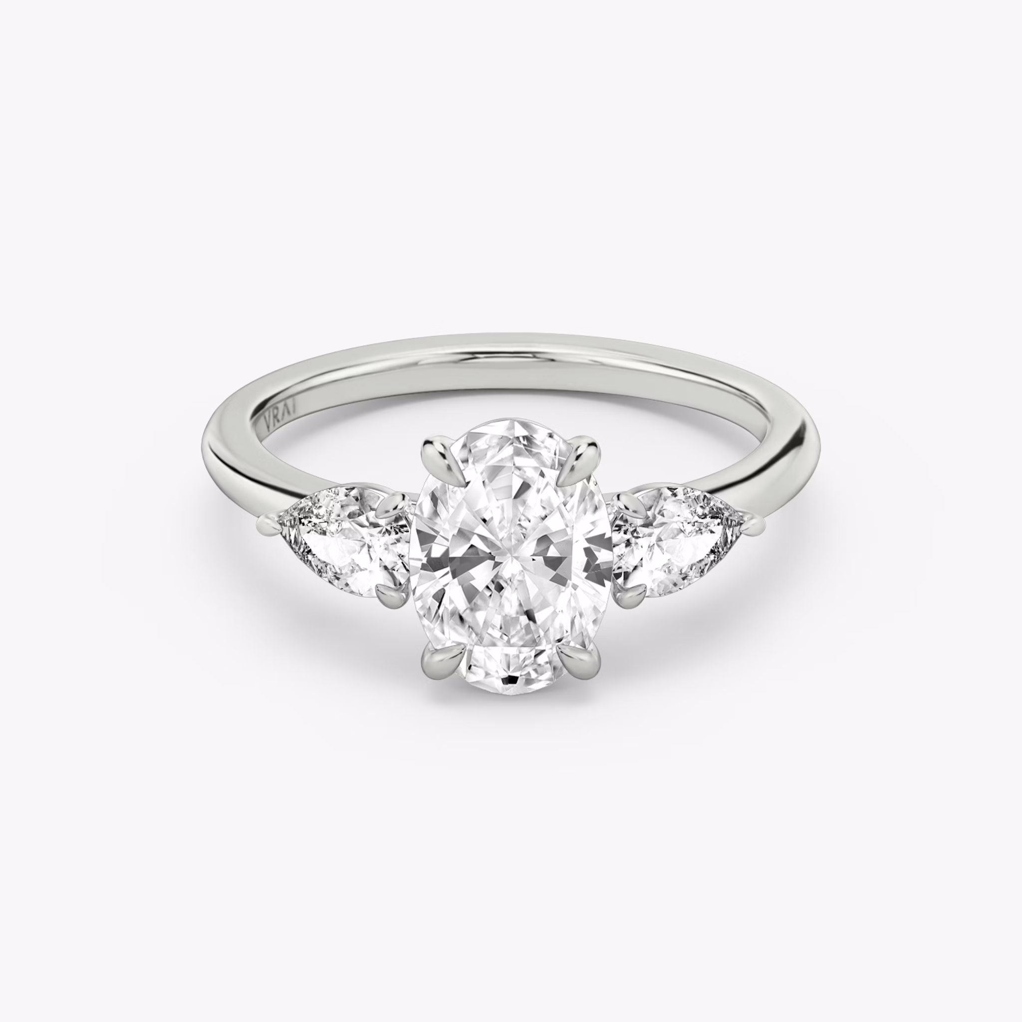 The Three Stone | Oval | Platinum | bandAccent: Plain | sideStoneCarat: 0.25ct | sideStoneShape: Pear | diamondOrientation: vertical | caratWeight: other