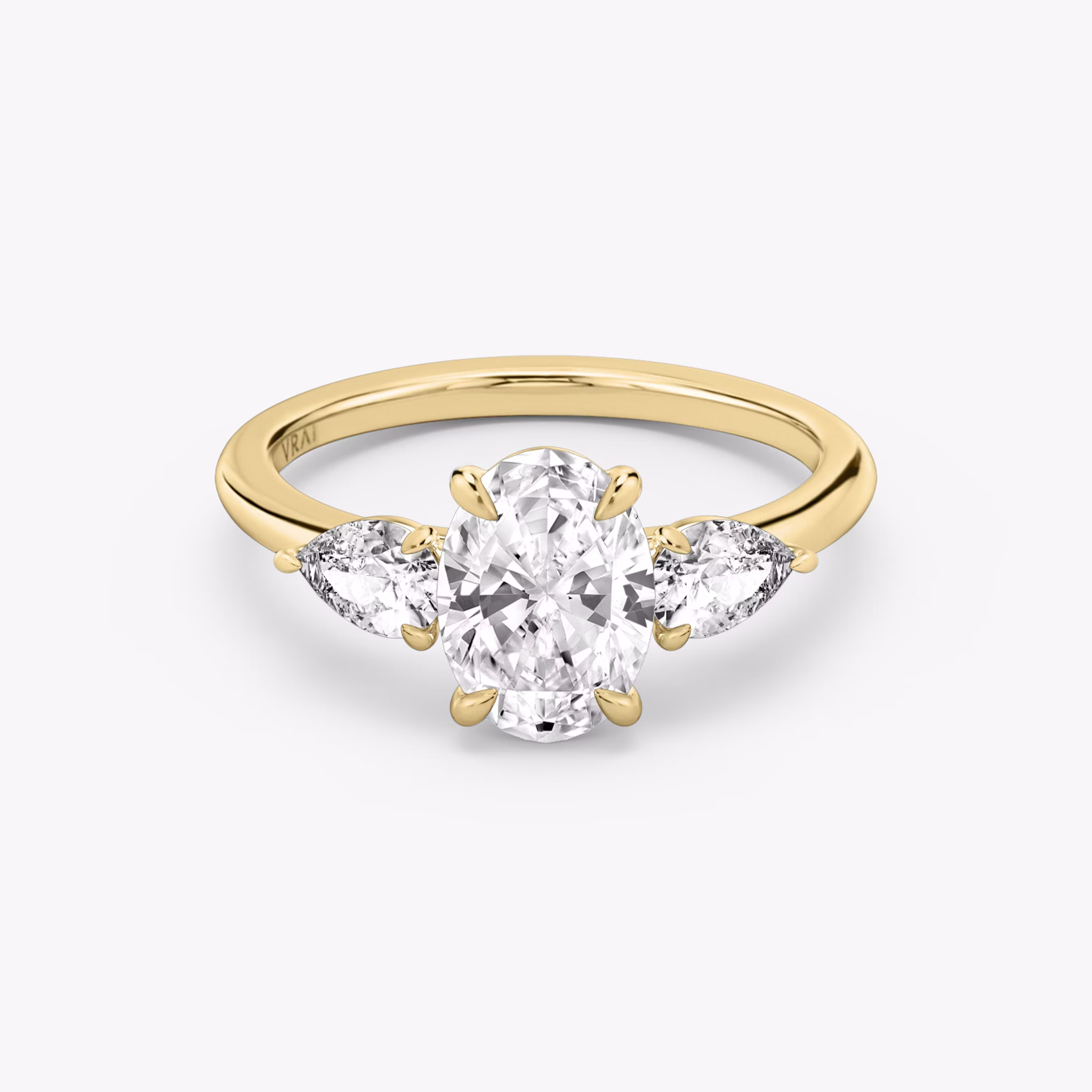 The Three Stone | Oval | 18k | Yellow Gold | bandAccent: Plain | sideStoneCarat: 0.25ct | sideStoneShape: Pear | diamondOrientation: vertical | caratWeight: other