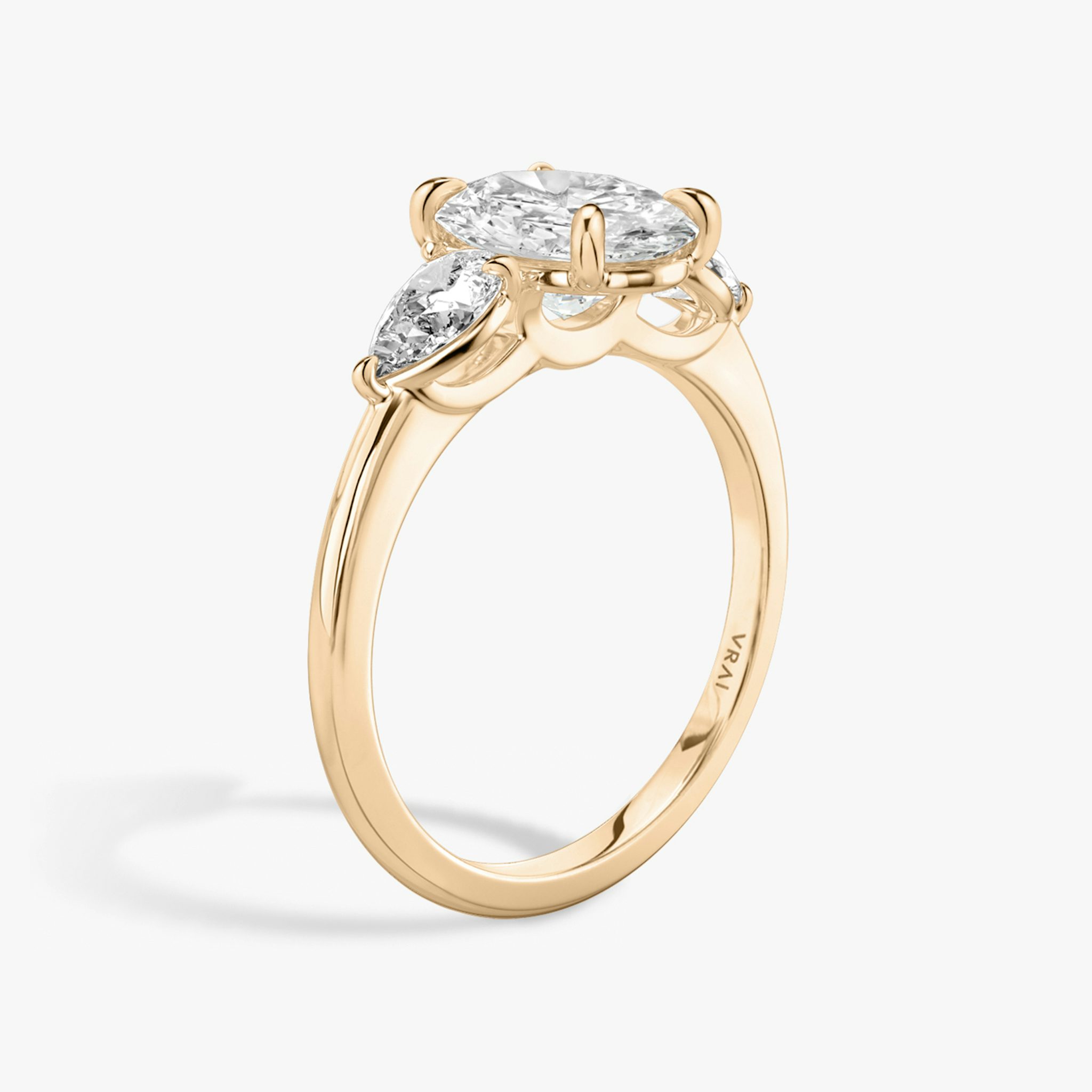 The Three Stone | Oval | 14k | Rose Gold | bandAccent: Plain | sideStoneCarat: 0.25ct | sideStoneShape: Pear | diamondOrientation: vertical | caratWeight: other