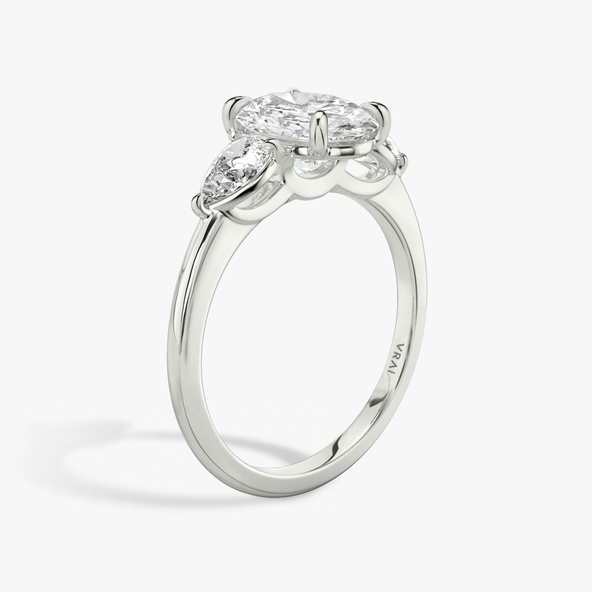 The Three Stone | Oval | Platinum | bandAccent: Plain | sideStoneCarat: 0.25ct | sideStoneShape: Pear | diamondOrientation: vertical | caratWeight: other