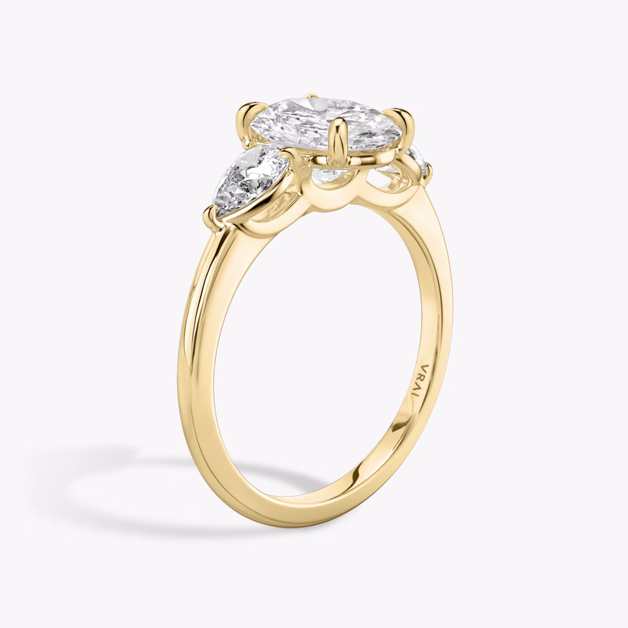 The Three Stone | Oval | 18k | Yellow Gold | bandAccent: Plain | sideStoneCarat: 0.25ct | sideStoneShape: Pear | diamondOrientation: vertical | caratWeight: other