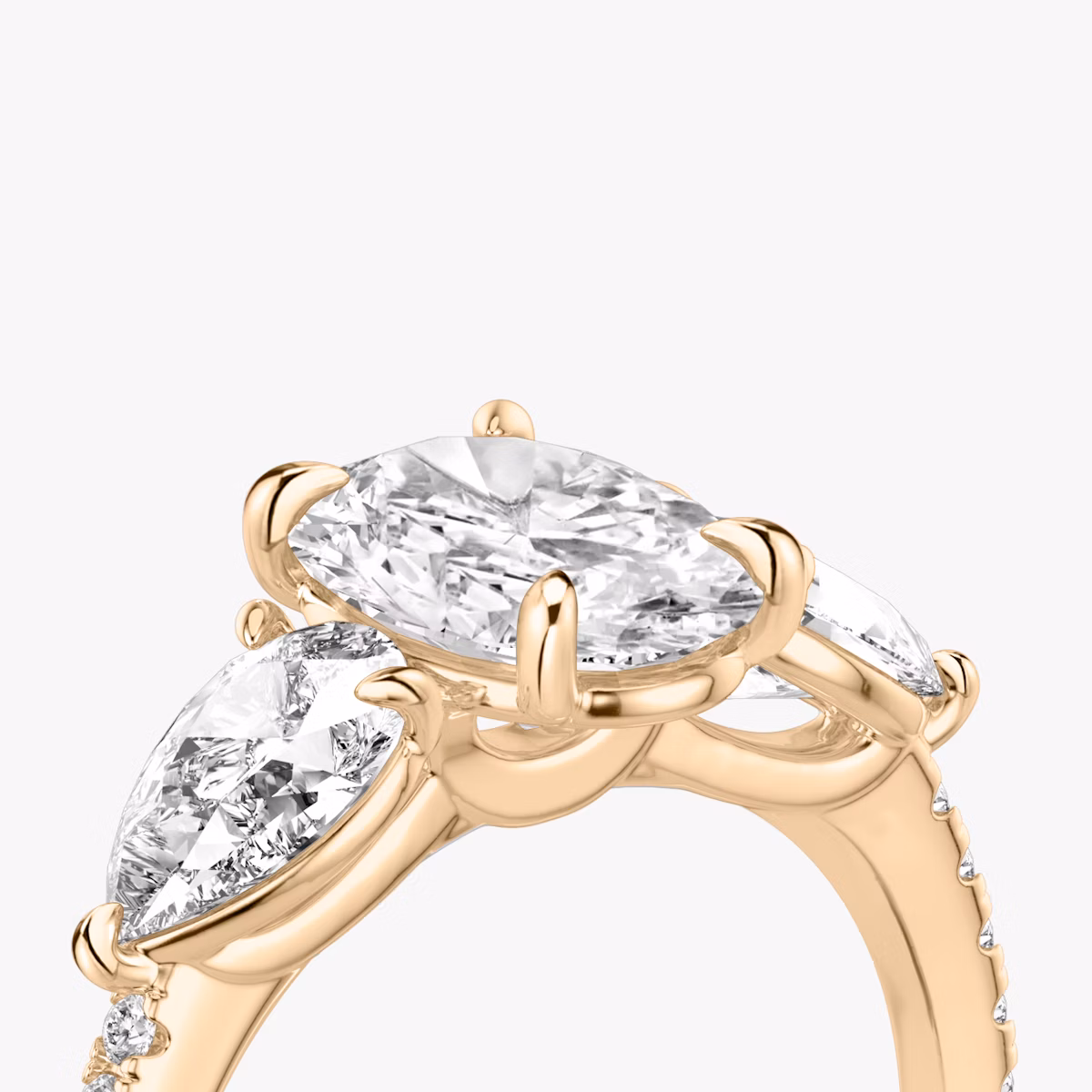 The Three Stone | Oval | 14k | Rose Gold | bandAccent: Pavé | sideStoneCarat: 0.50ct | sideStoneShape: Pear | diamondOrientation: vertical | caratWeight: other