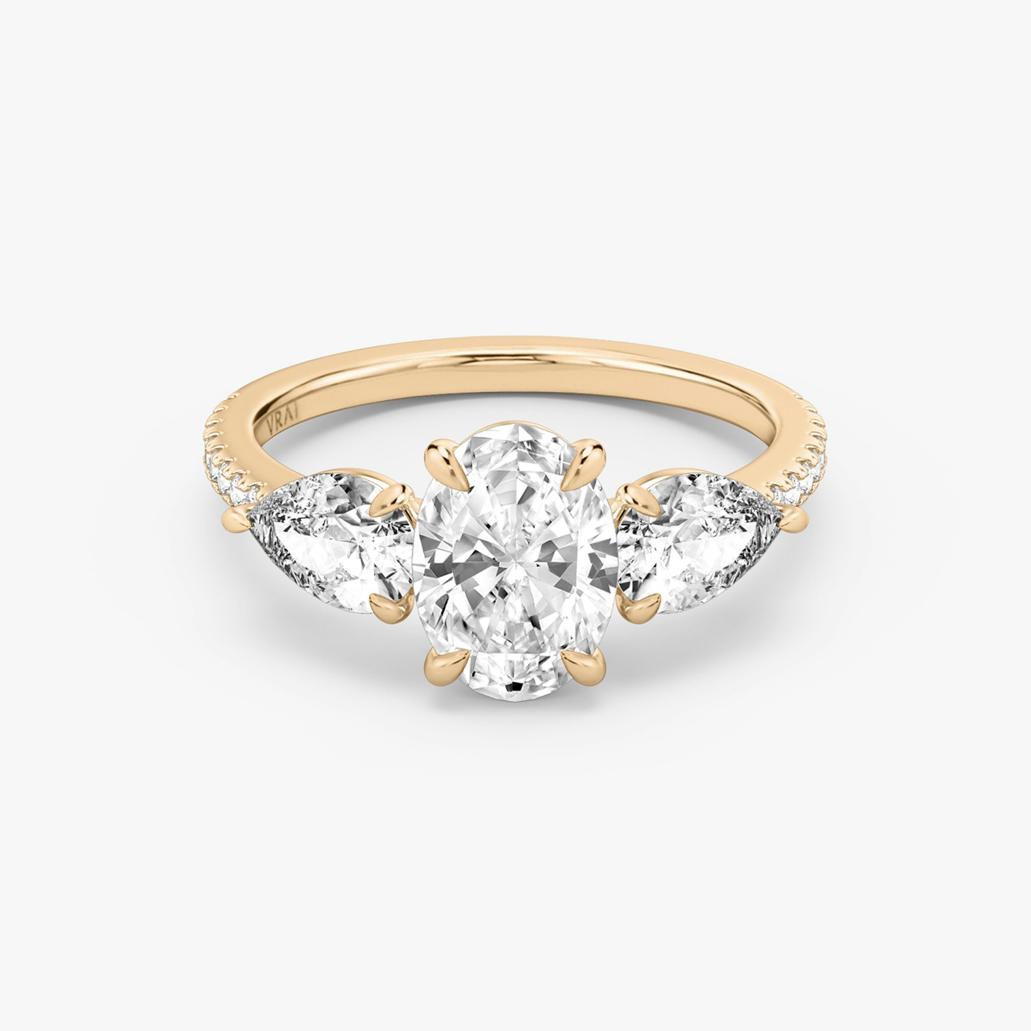 The Three Stone | Oval | 14k | Rose Gold | bandAccent: Pavé | sideStoneCarat: 0.50ct | sideStoneShape: Pear | diamondOrientation: vertical | caratWeight: other
