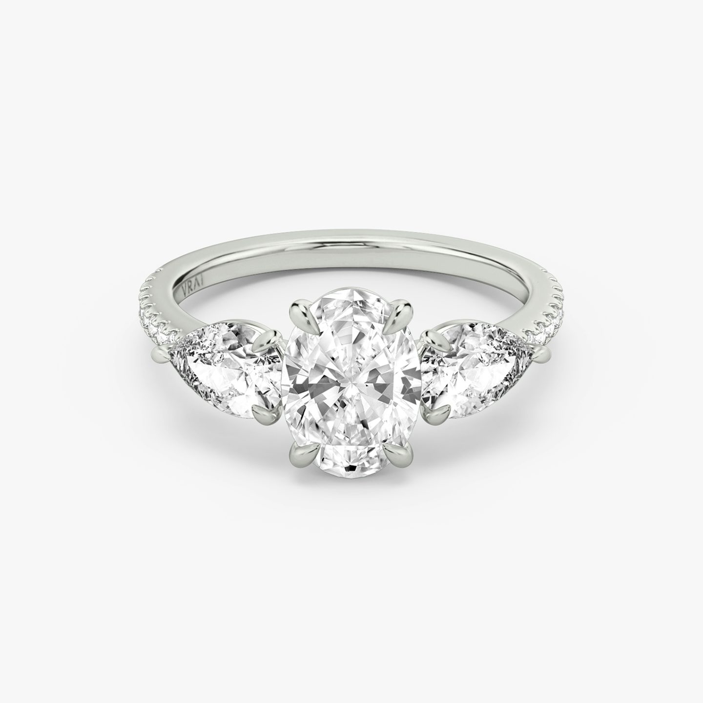The Three Stone | Oval | Platinum | bandAccent: Pavé | sideStoneCarat: 0.50ct | sideStoneShape: Pear | diamondOrientation: vertical | caratWeight: other