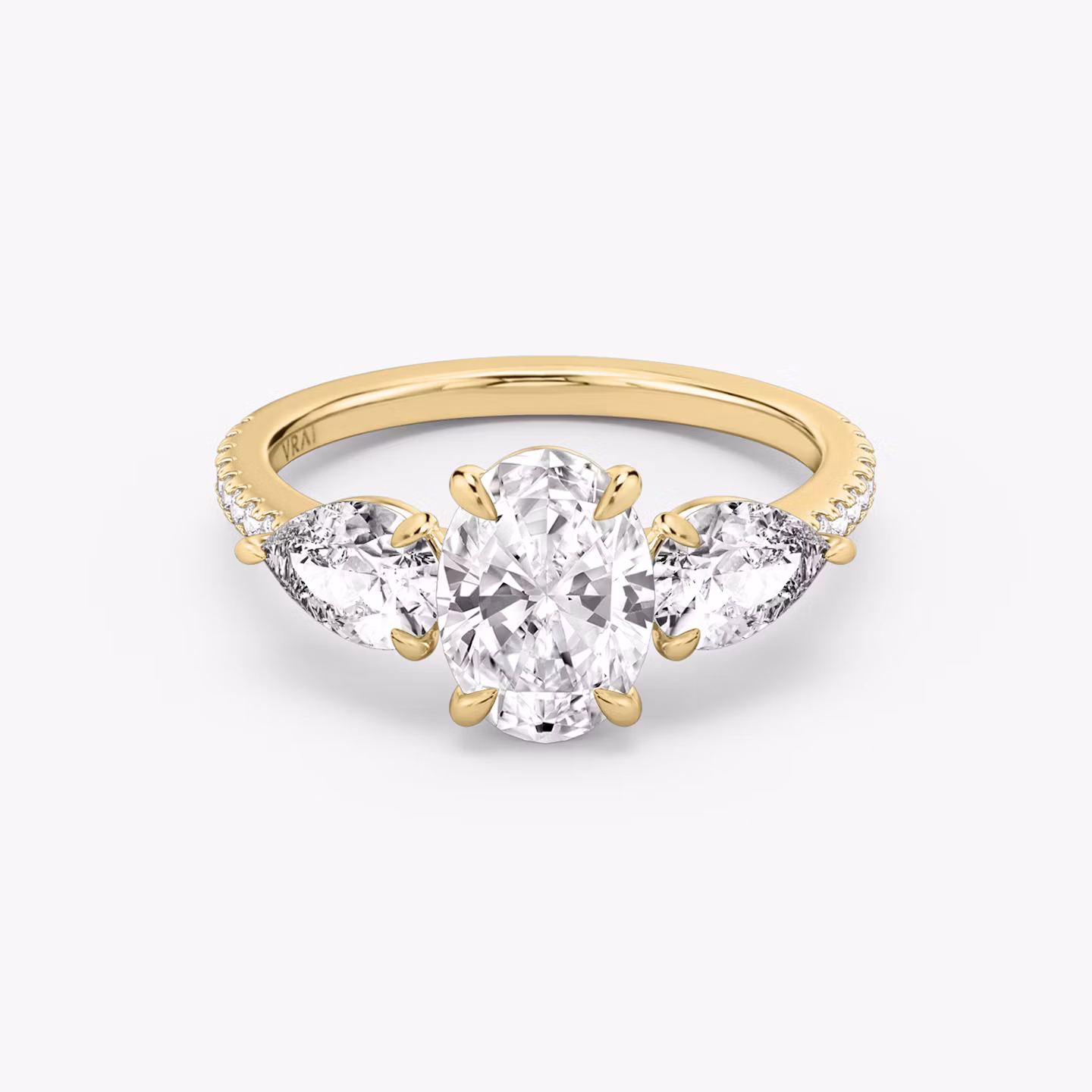 The Three Stone | Oval | 18k | Yellow Gold | bandAccent: Pavé | sideStoneCarat: 0.50ct | sideStoneShape: Pear | diamondOrientation: vertical | caratWeight: other