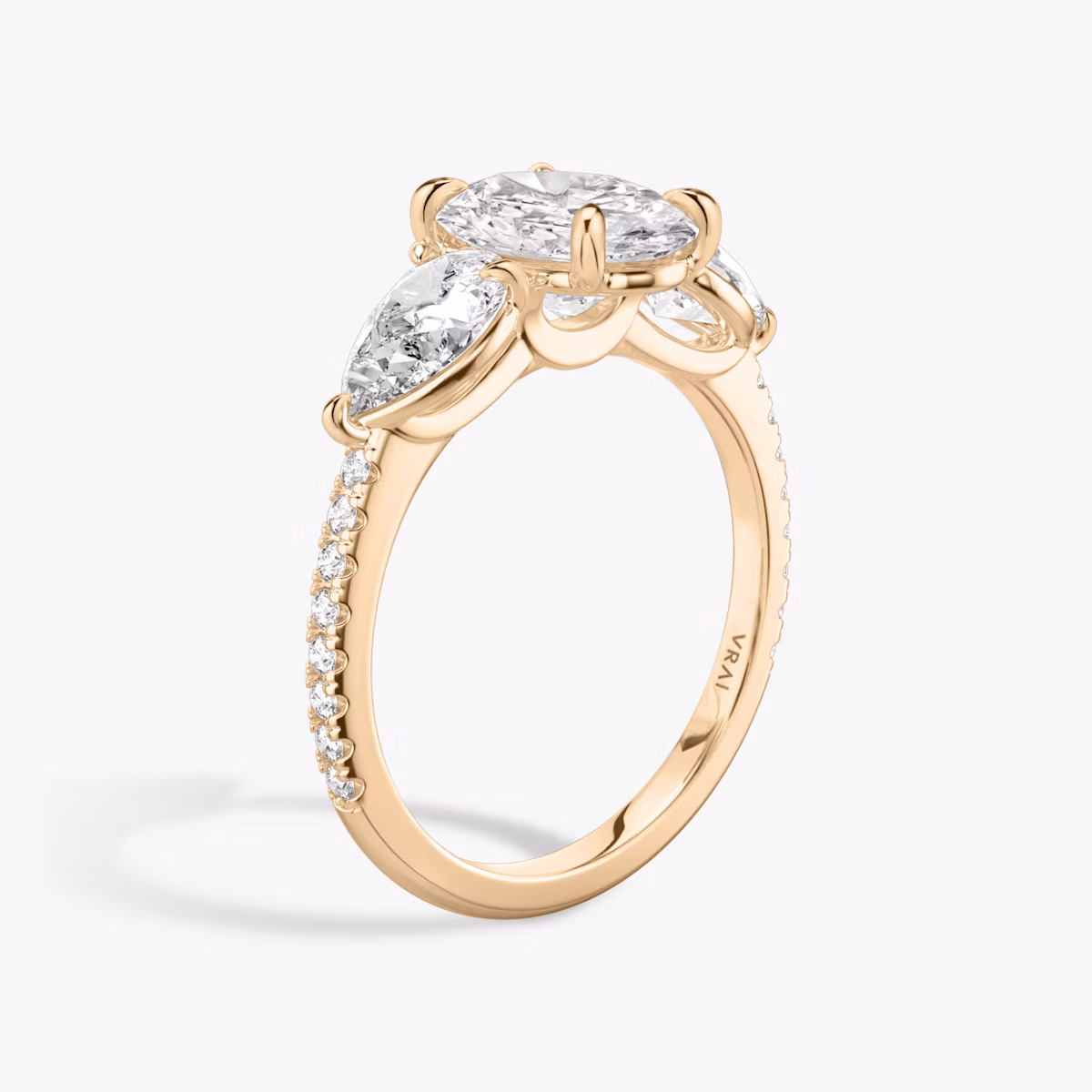 The Three Stone | Oval | 14k | Rose Gold | bandAccent: Pavé | sideStoneCarat: 0.50ct | sideStoneShape: Pear | diamondOrientation: vertical | caratWeight: other
