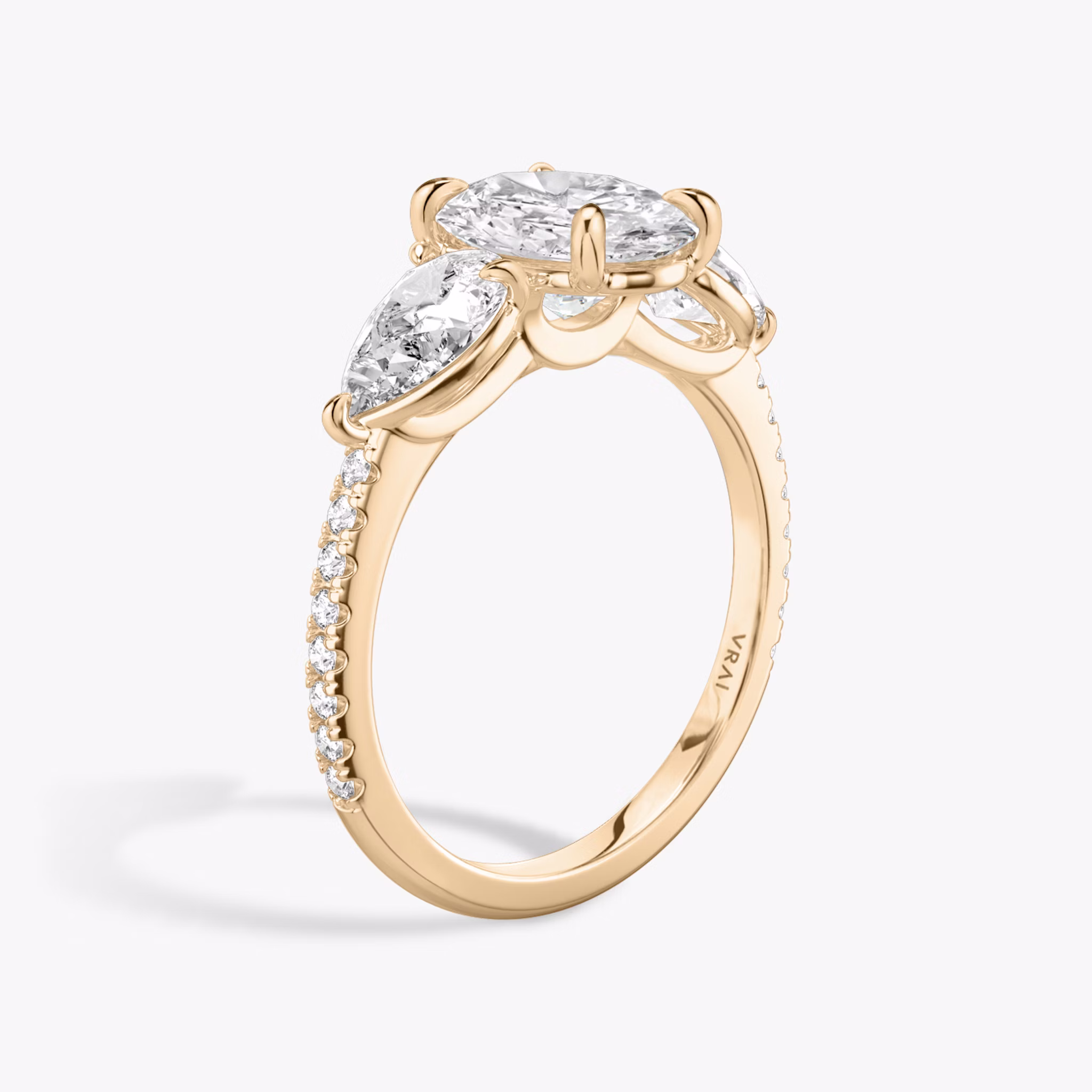 The Three Stone | Oval | 14k | Rose Gold | bandAccent: Pavé | sideStoneCarat: 0.50ct | sideStoneShape: Pear | diamondOrientation: vertical | caratWeight: other